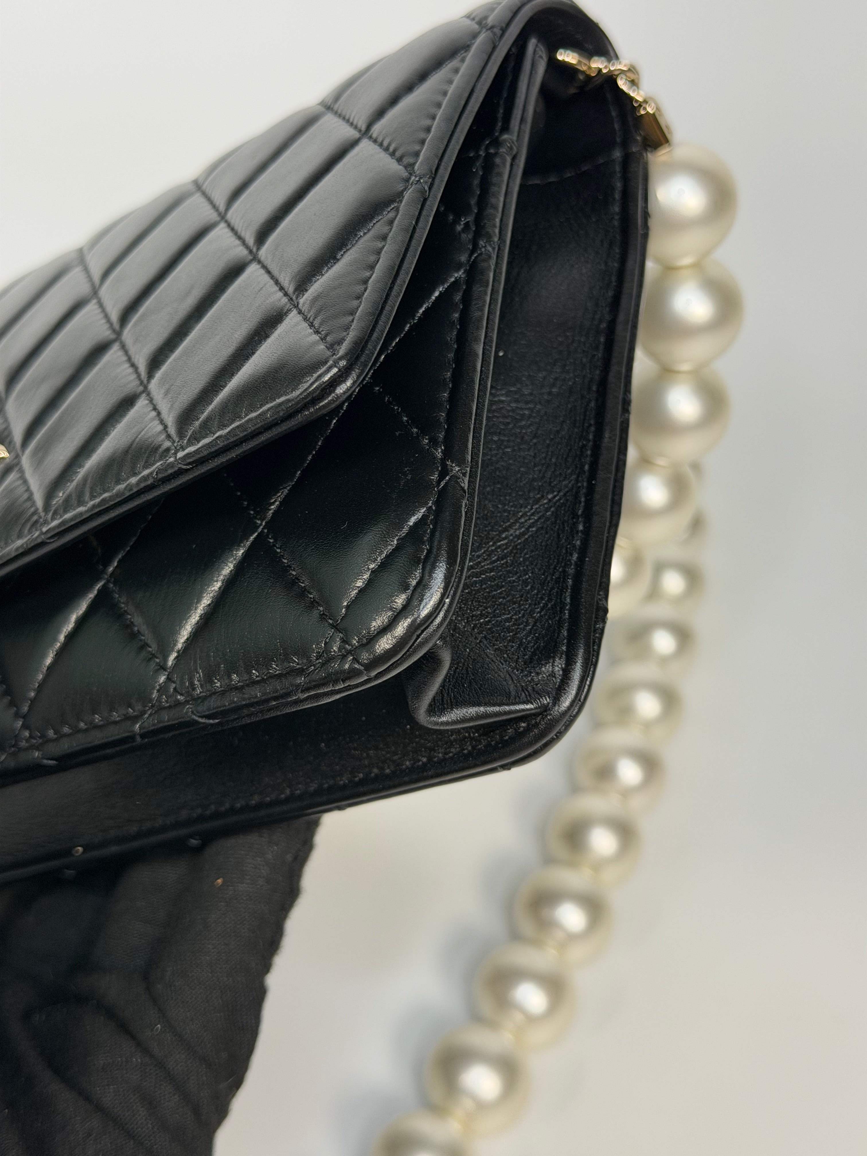 Chanel Pearl Wallet On Chain In Black Lambskin Leather With Gold Hardware. Authentic and preloved in very good condition.