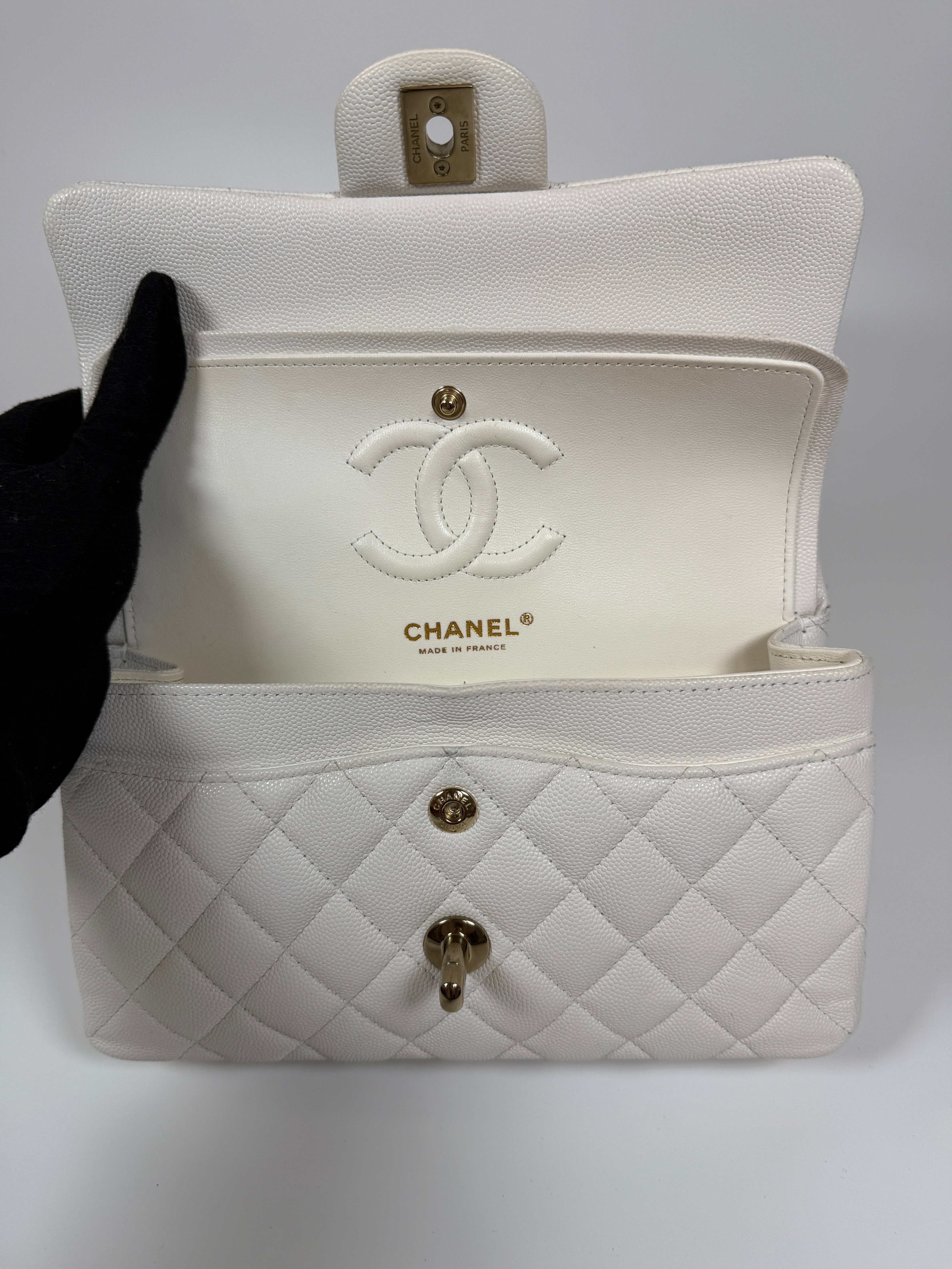 Authentic and preloved Chanel Small Classic Double Flap In White Caviar Leather With pale gold hardware. Very Good Condition. 100% Authenticity guarantee 