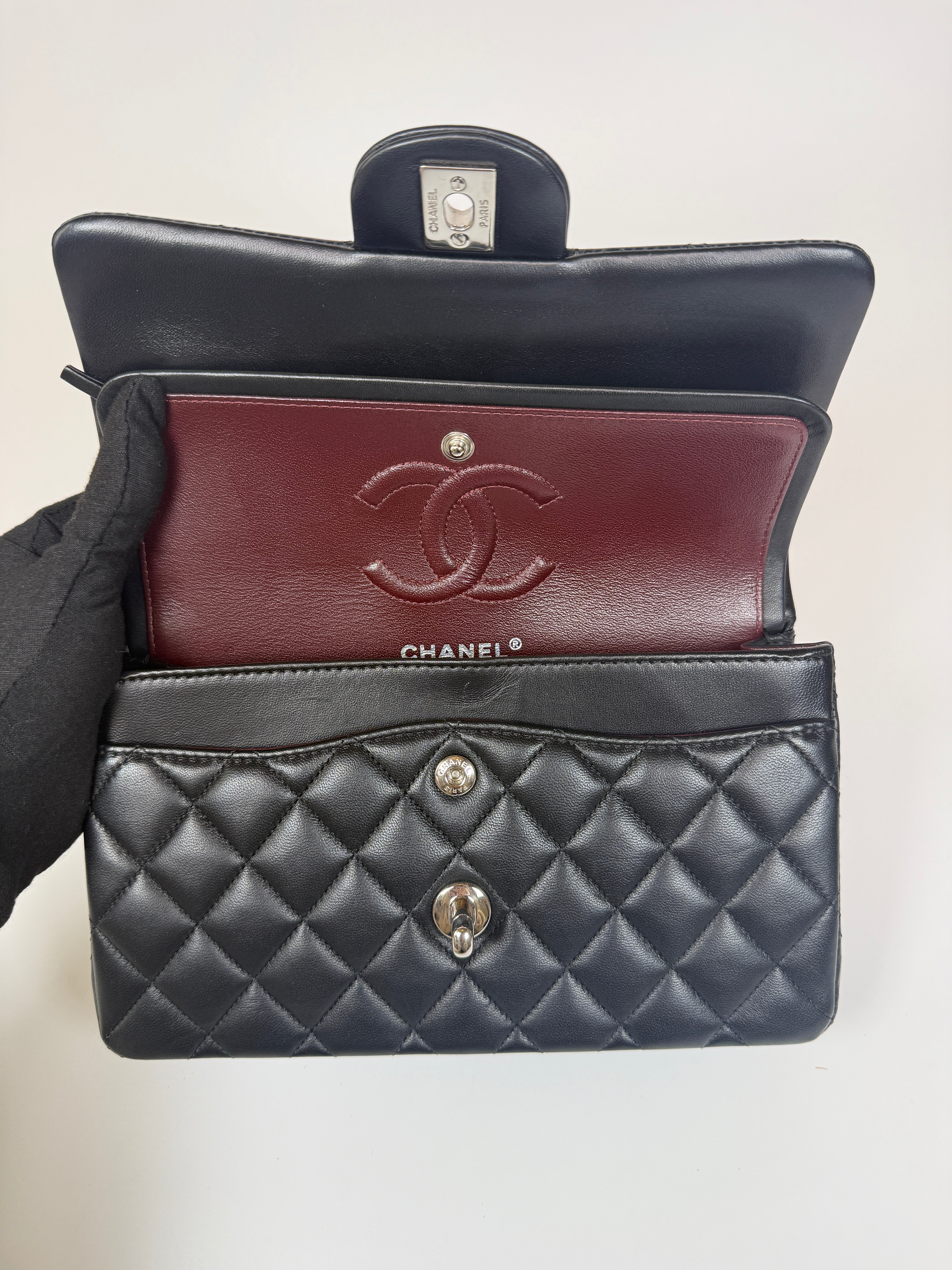 Authentic and preloved Chanel Small Classic Double Flap In Black Lambskin Leather With Silver hardware 100% Authenticity guarantee