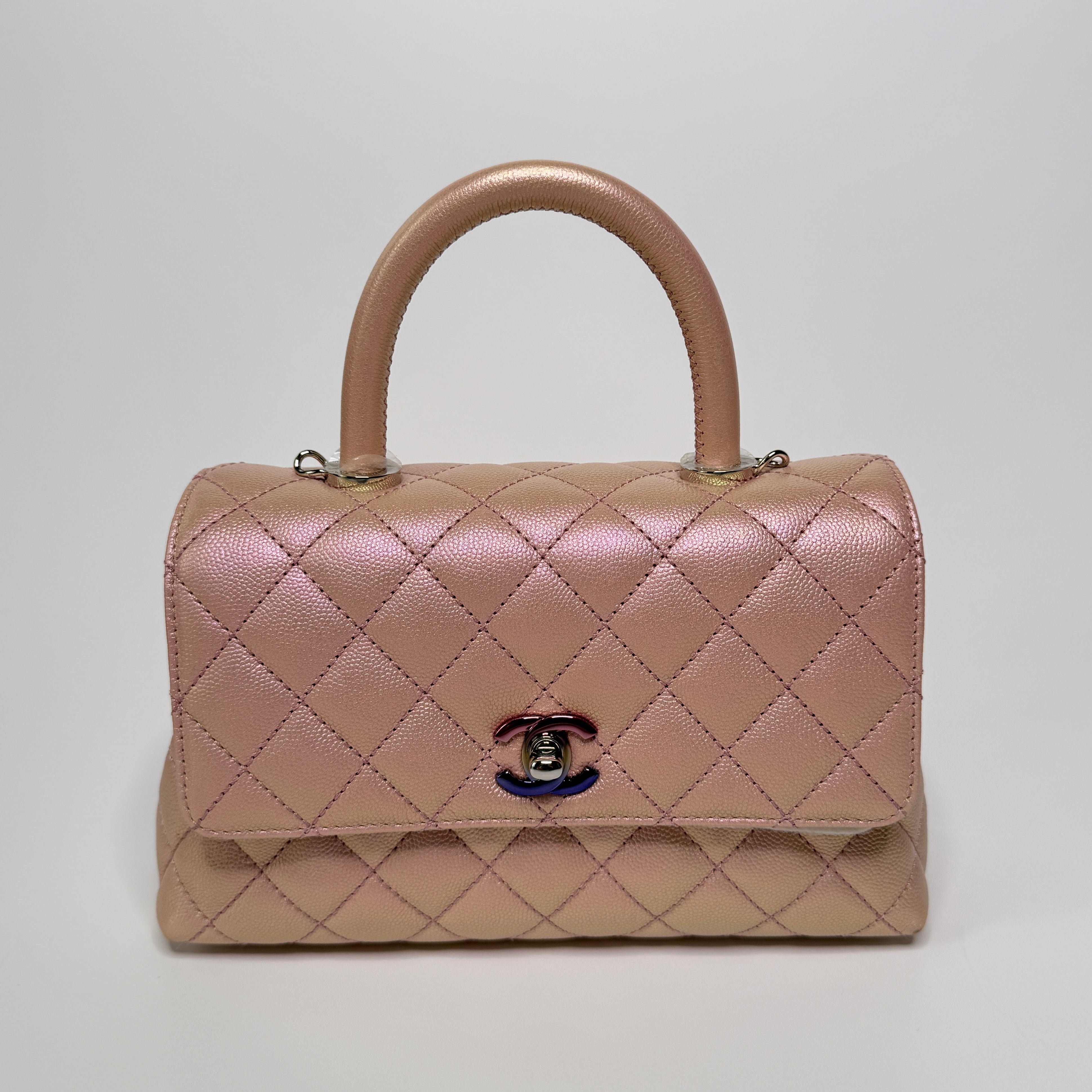 Authentic pre-loved Chanel Small Coco In Iridescent Pink Caviar With Rainbow Hardware. 