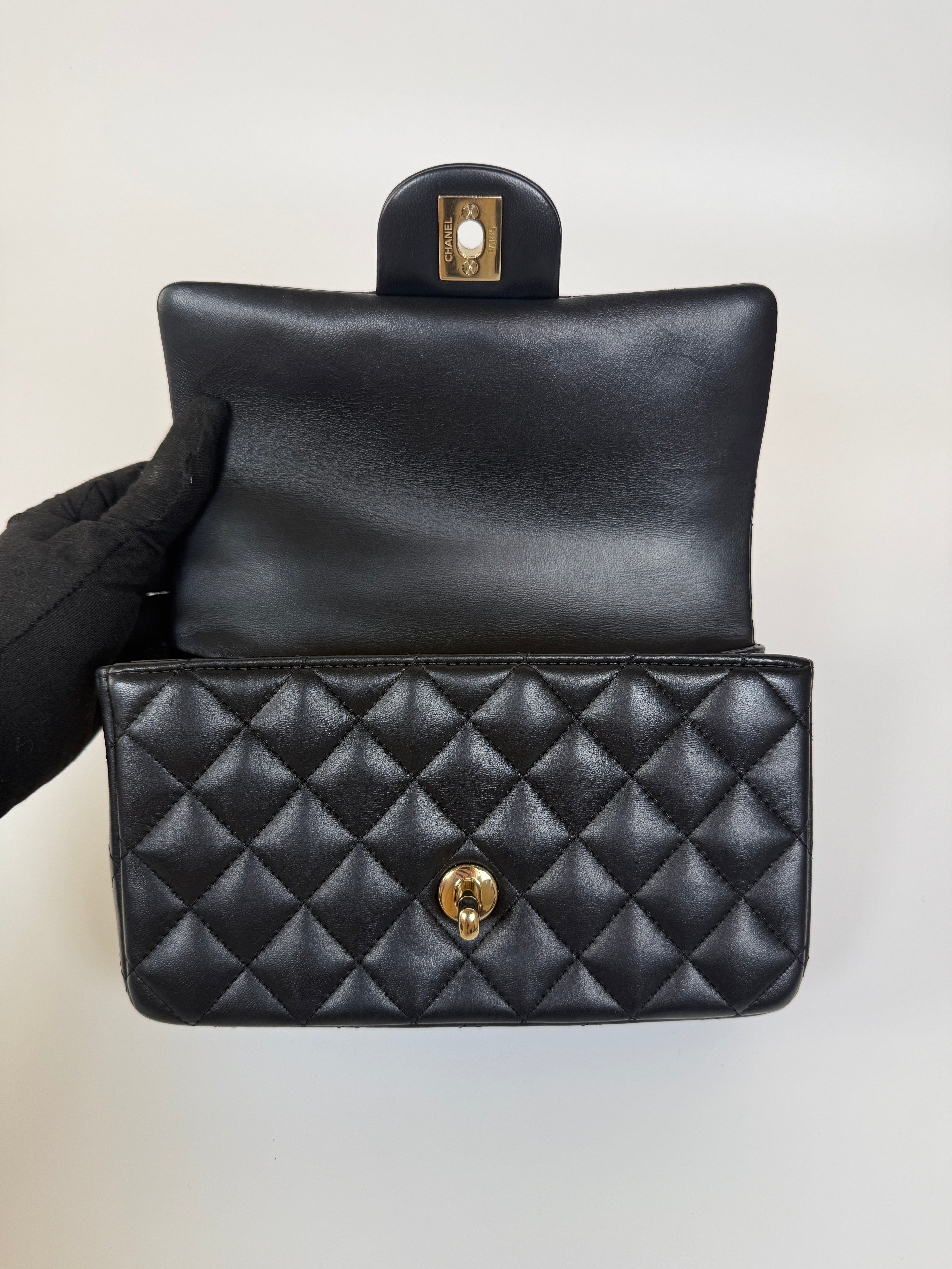 Authentic and preloved Chanel Mini Rectangle Top Handle Flap Bag In Black Lambskin With Gold hardware. Excellent Condition. 100% Authenticity guarantee 