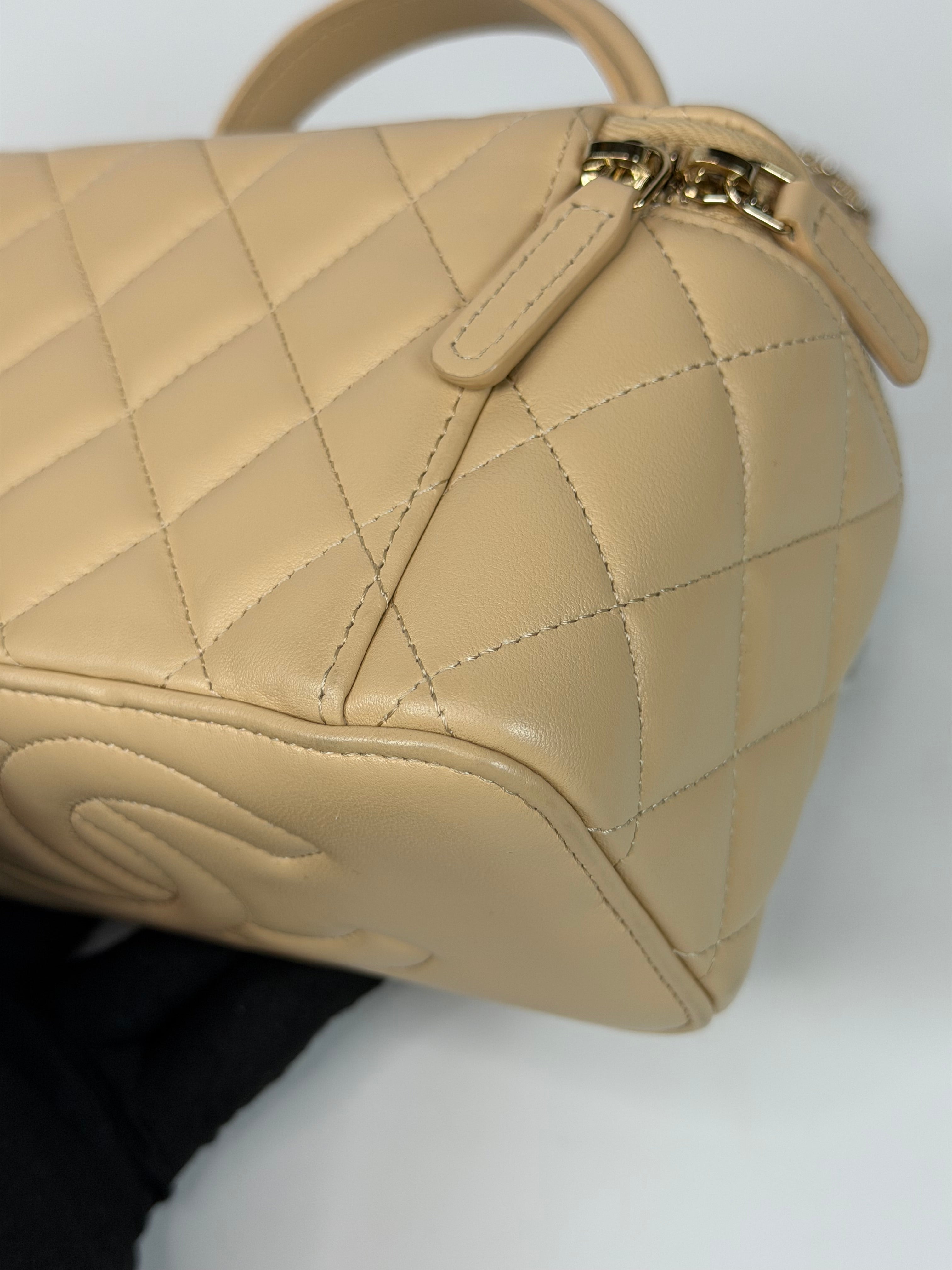 Chanel Mini Vanity Top Handle In Light Beige Lambskin Leather With Gold Hardware. Authentic and preloved in excellent condition. Insured next day delivery. Verified by Luxe Cheshire