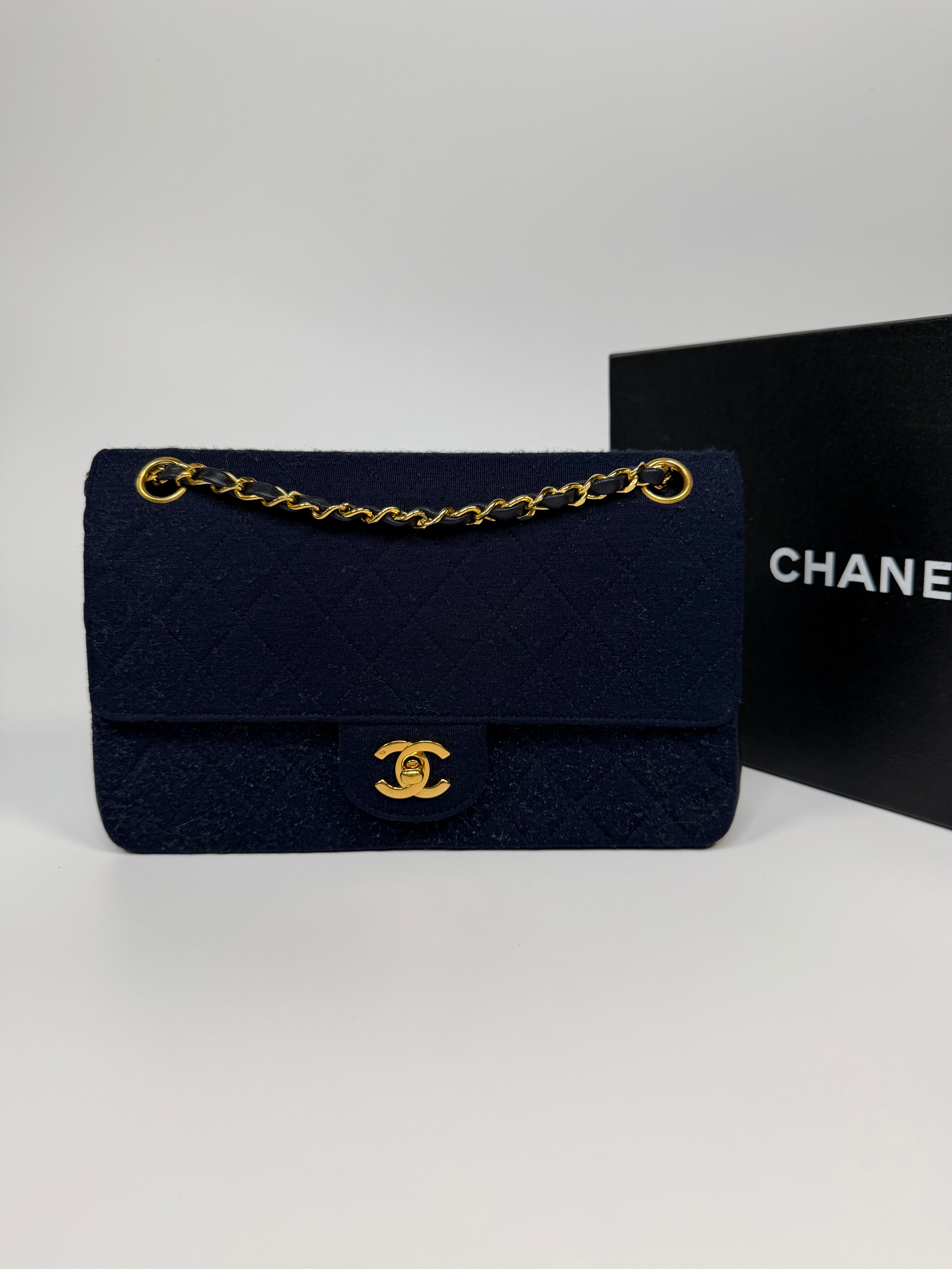 Chanel Vintage Medium Double Flap Navy Cotton With 24Kt Gold Hardware. Authentic and preloved in excellent condition.