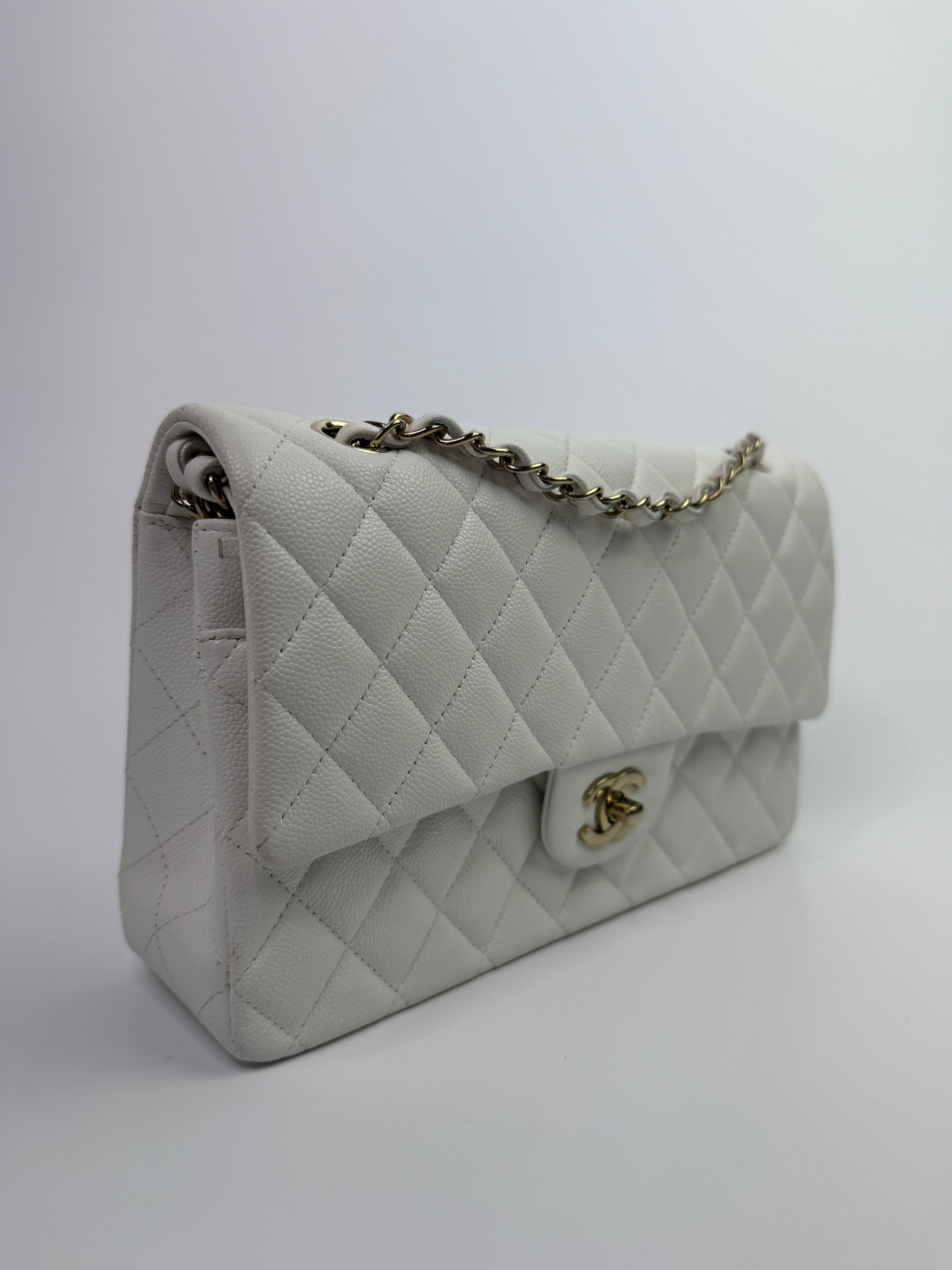 Authentic pre-loved Chanel Medium Classic Double Flap White Caviar Leather With Gold Hardware. 