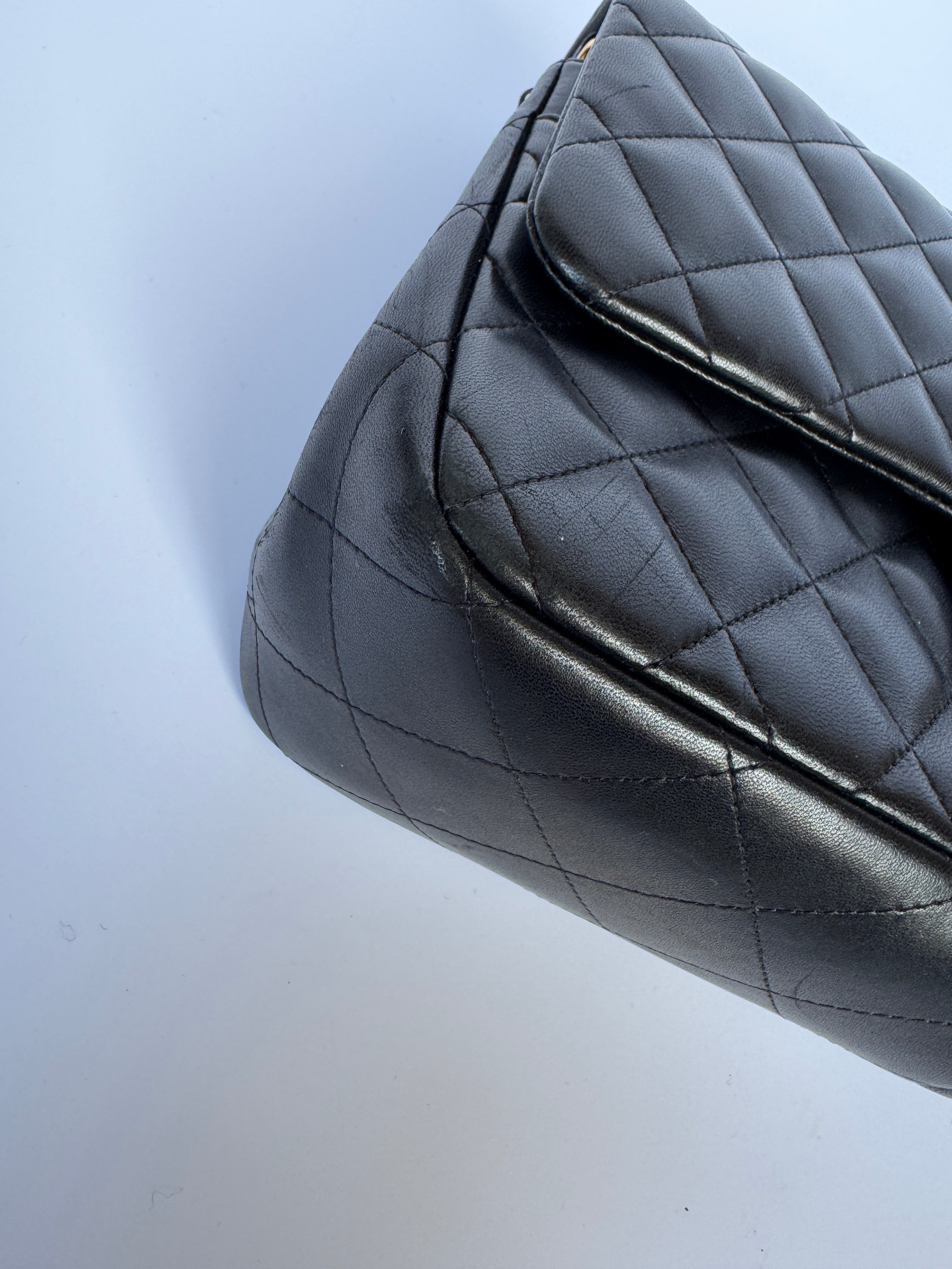 Authentic pre-loved Chanel Black Lambskin Leather Jumbo Classic Double Flap With Gold Hardware. 