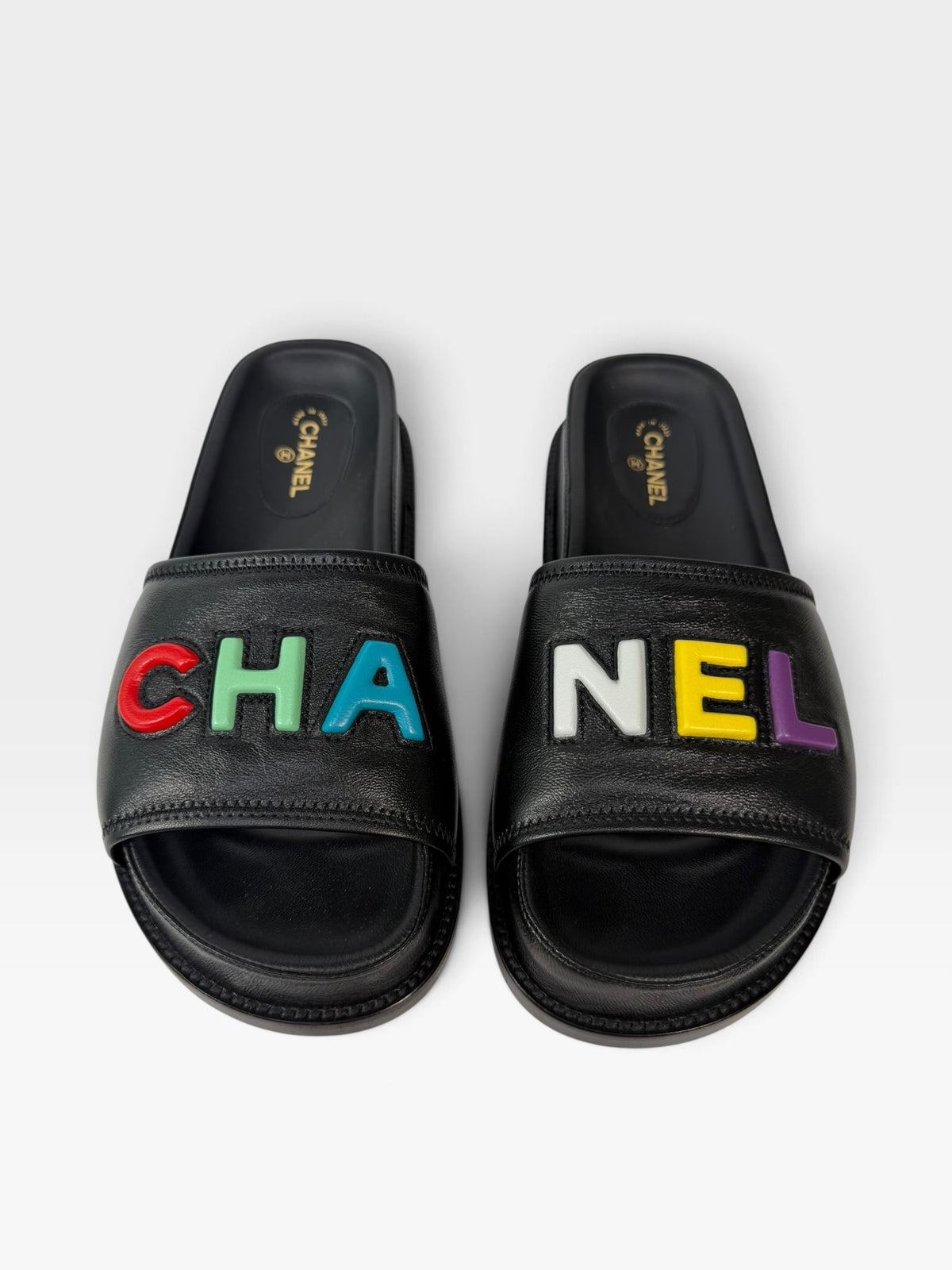 Chanel Multicolour Logo Slide Sandals In Black Leather. 100% authentic and preloved in excellent condition