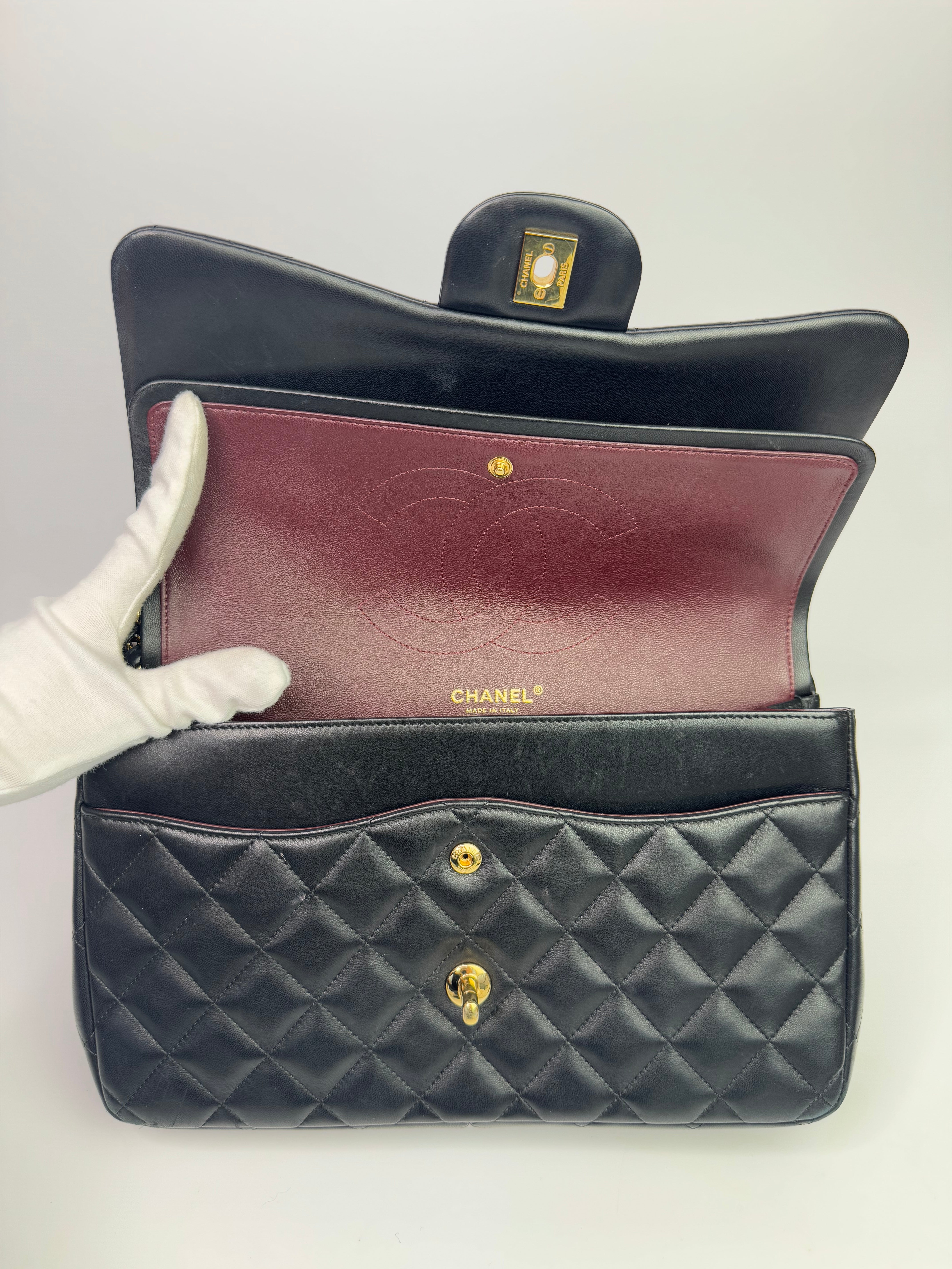 Authentic pre-loved Chanel Black Lambskin Leather Jumbo Classic Double Flap With Gold Hardware. 