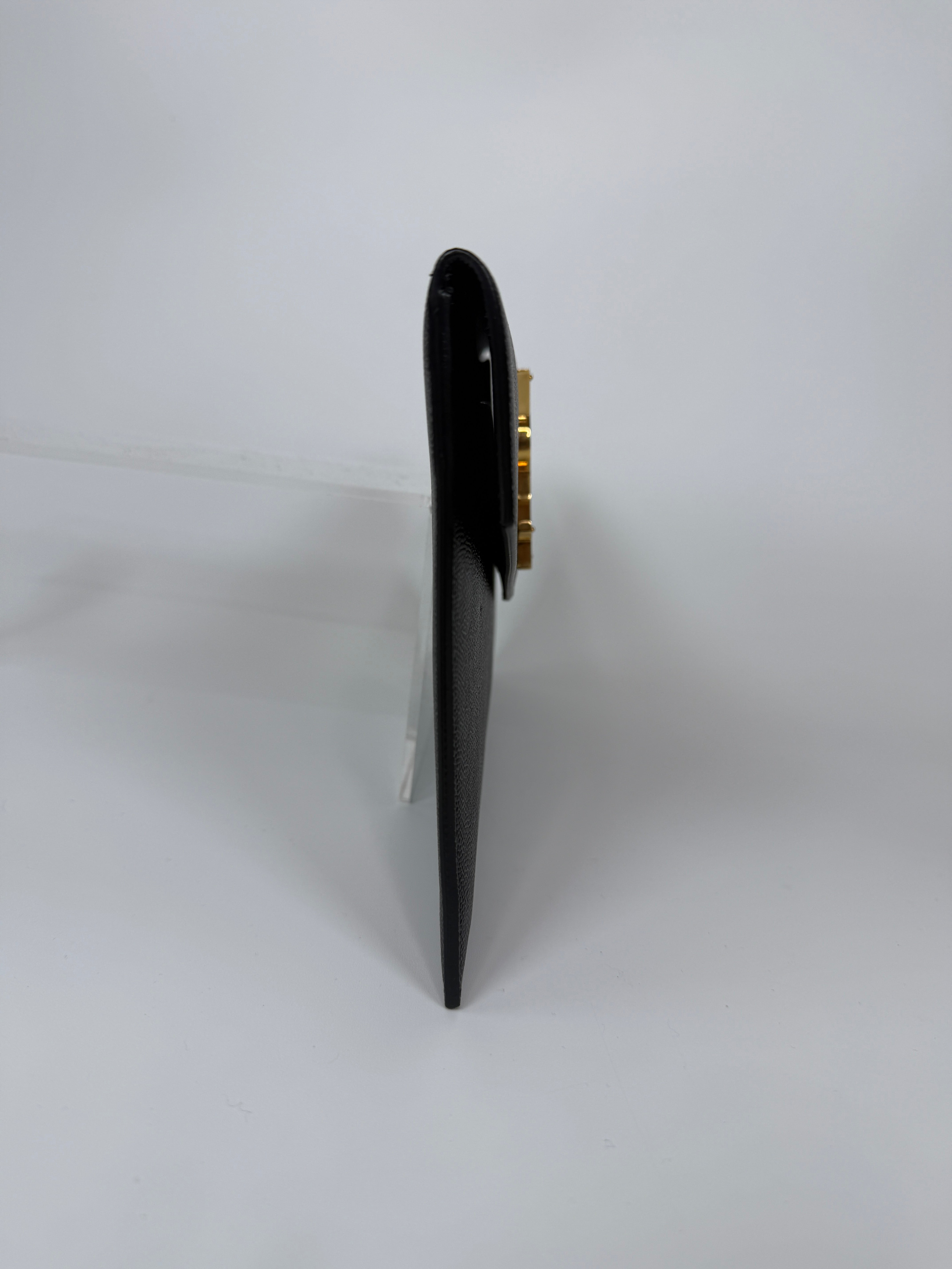 Saint Laurent Uptown Clutch In Black Leather With Gold Hardware. Authentic and preloved, 100% authenticity guarantee 