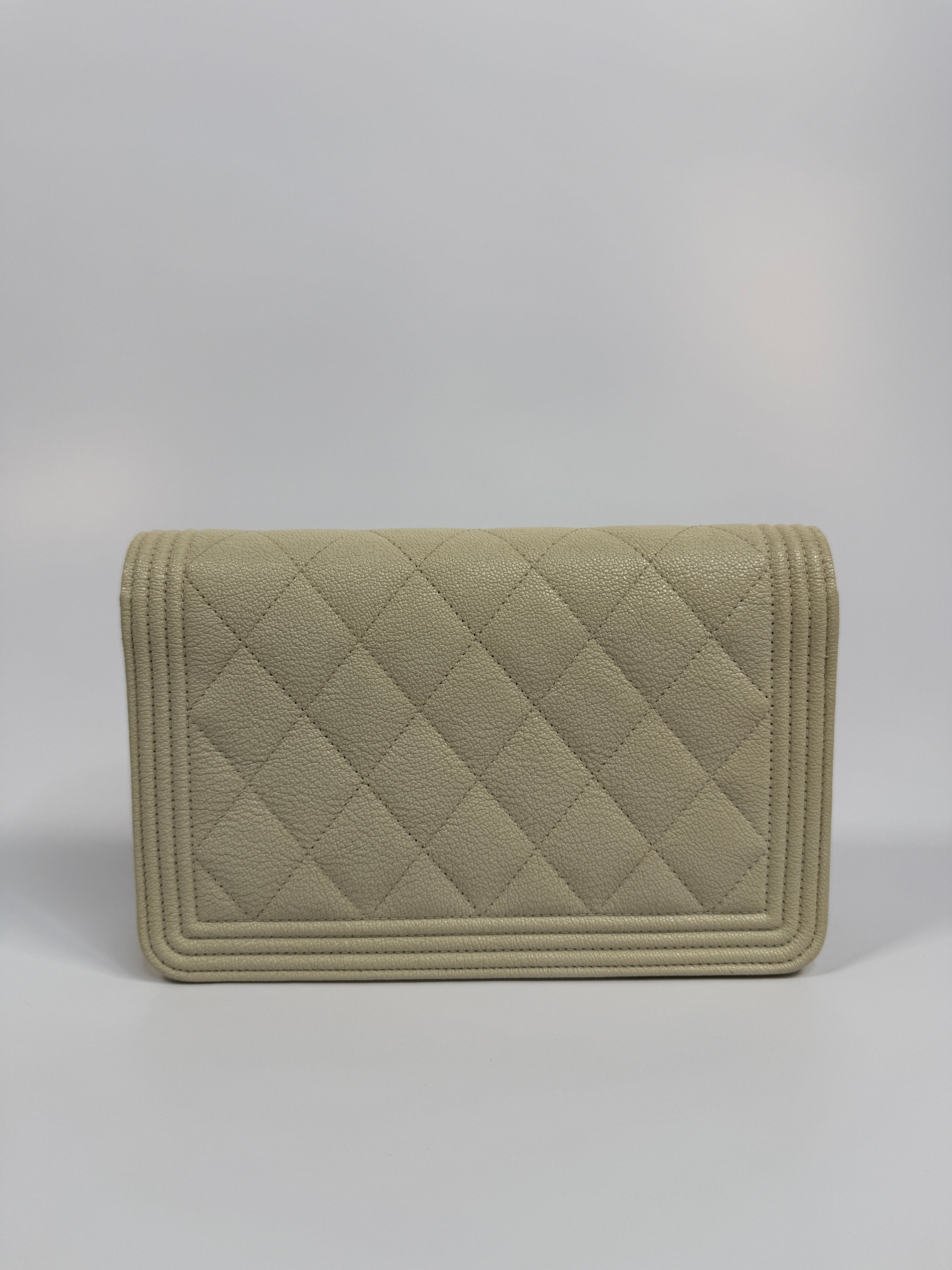 Authentic and pre loved Chanel Boy Wallet On Chain In White Caviar Leather With Gold Hardware. Excellent Condition