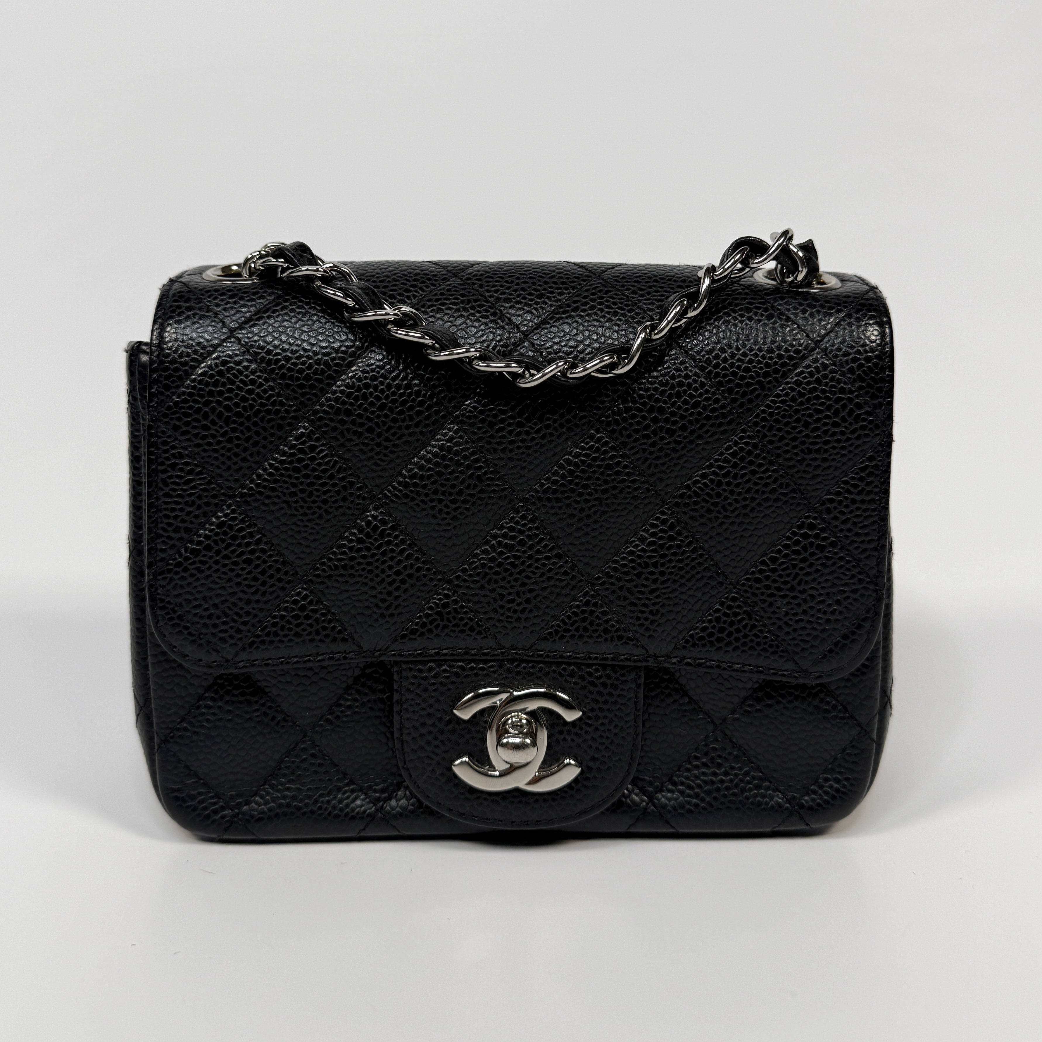 Chanel Black Square Flap Bag In Black Caviar Leather With Silver Hardware. Excellent condition. Authentic and preloved.