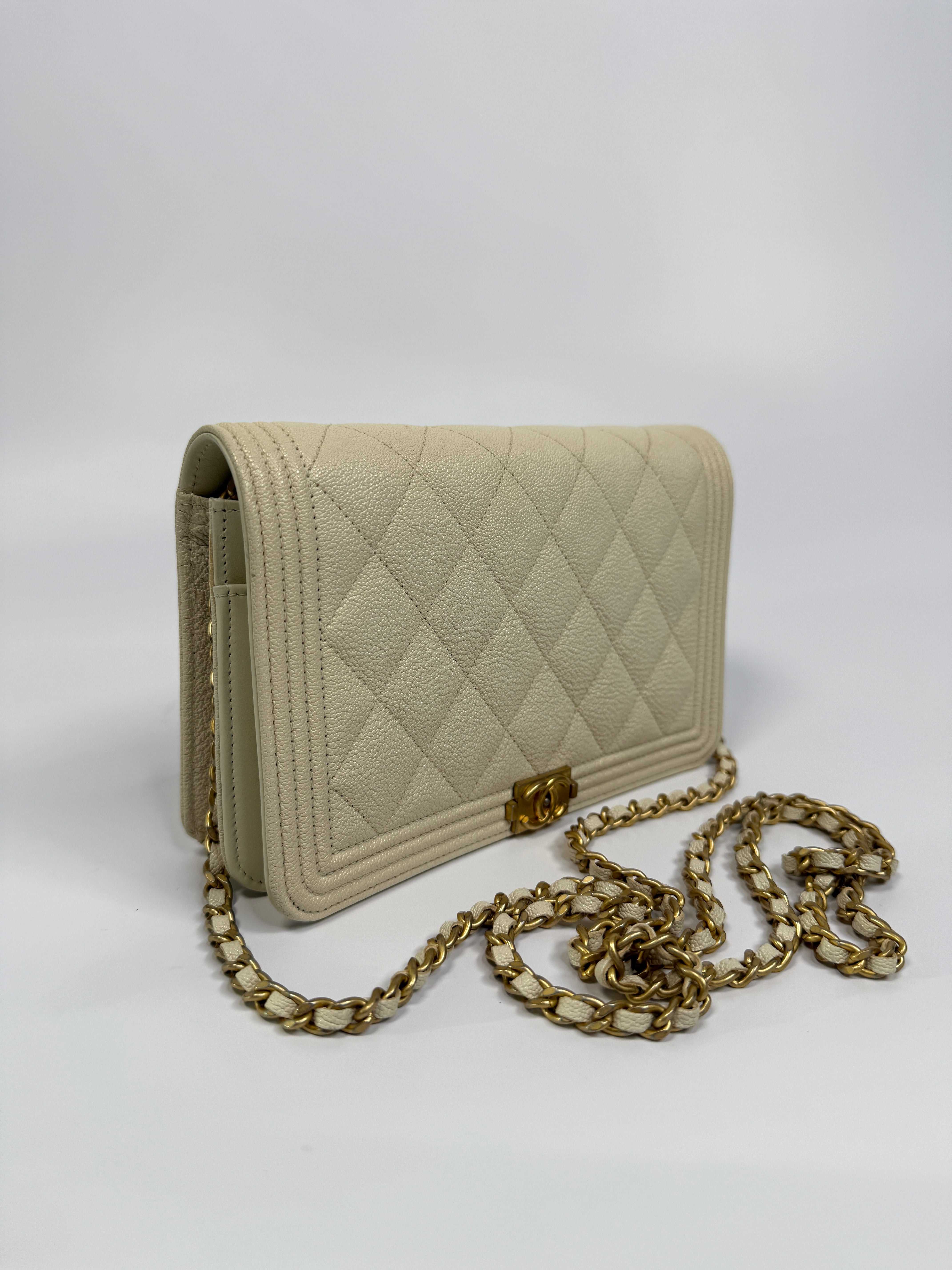 Authentic and pre loved Chanel Boy Wallet On Chain In White Caviar Leather With Gold Hardware. Excellent Condition
