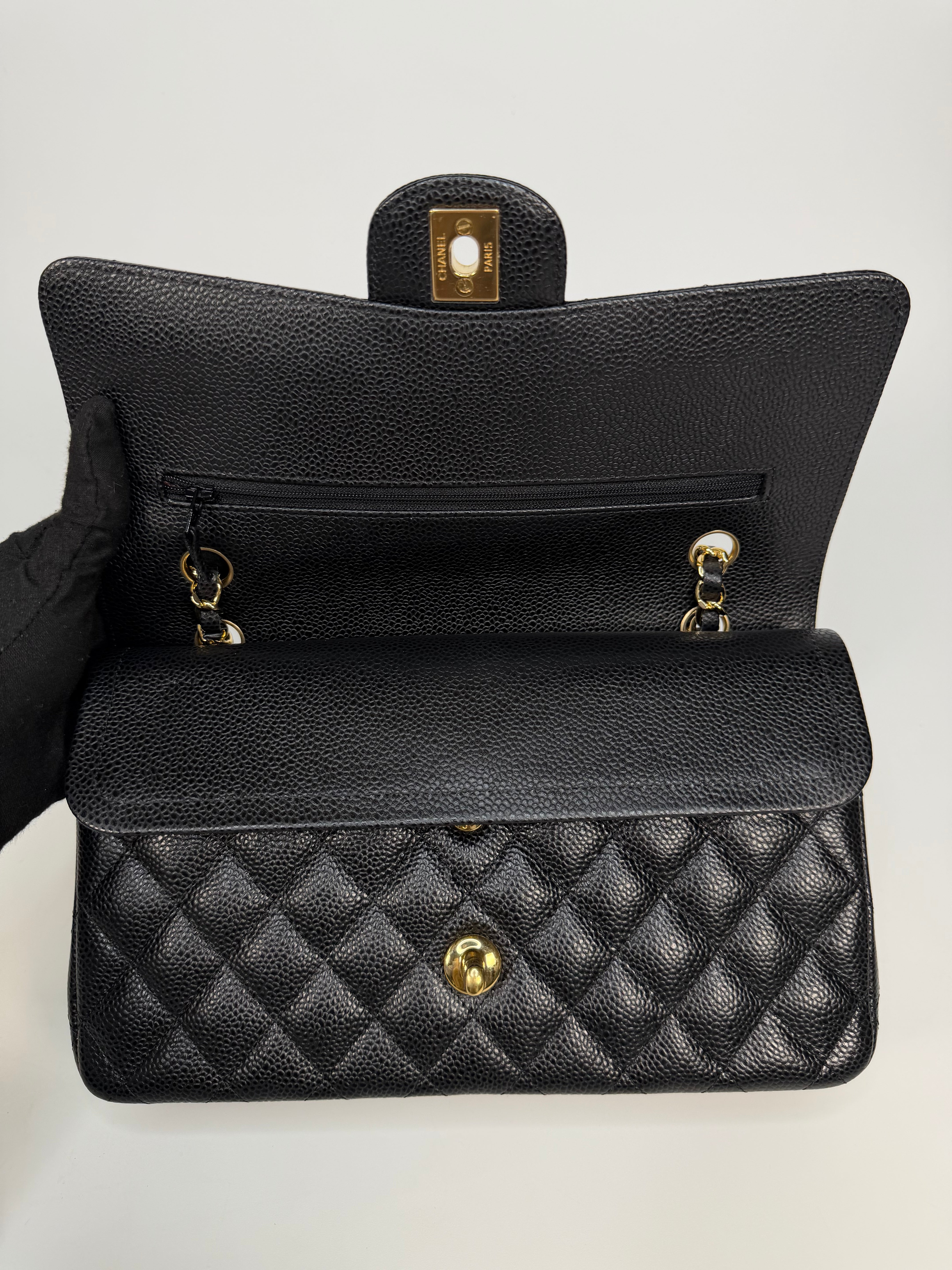 Chanel Medium Classic Double Flap In Black Caviar With Gold Hardware. Authentic and preloved in new and unused condition. 