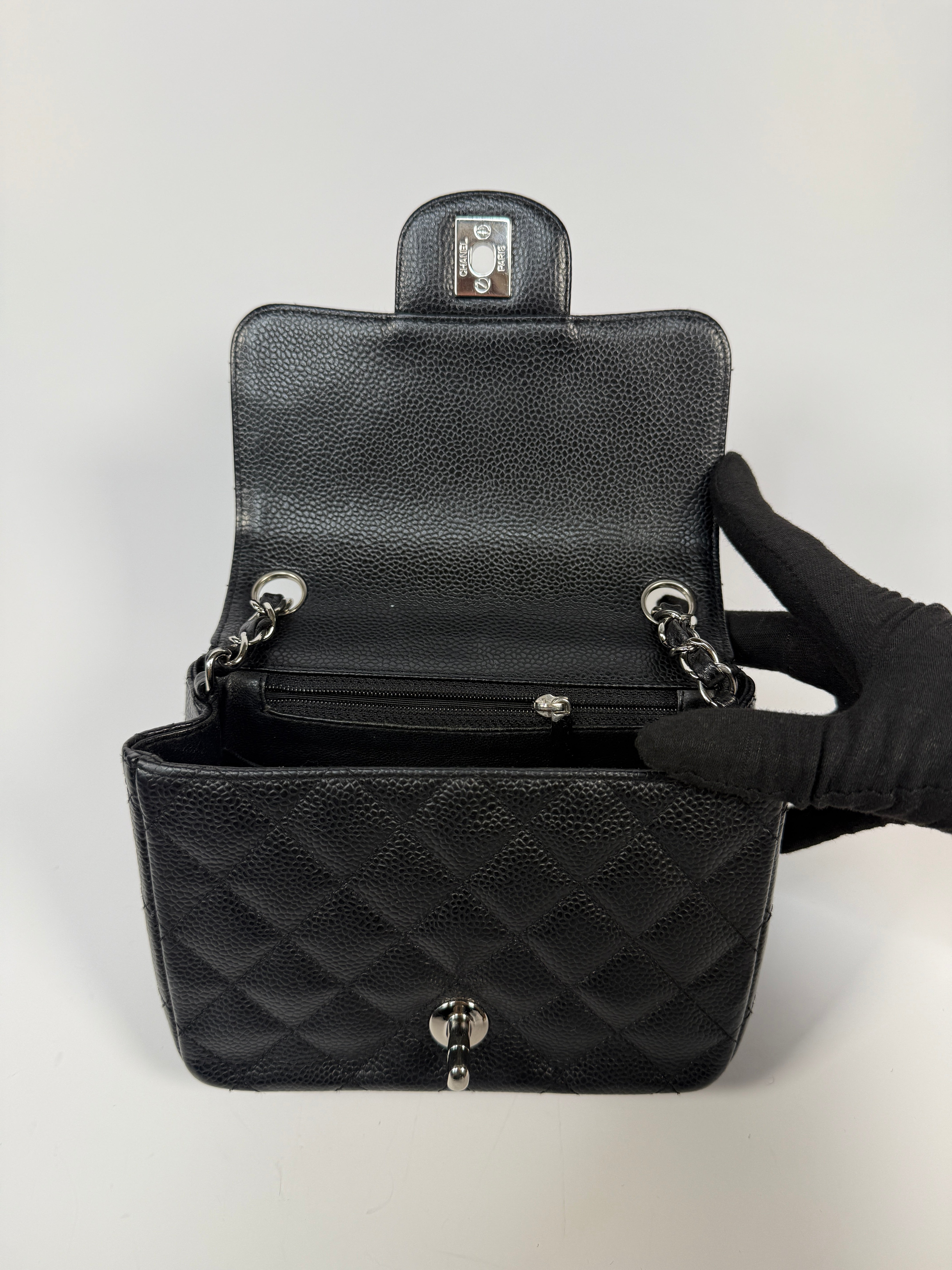 Chanel Black Square Flap Bag In Black Caviar Leather With Silver Hardware. Excellent condition. Authentic and preloved.