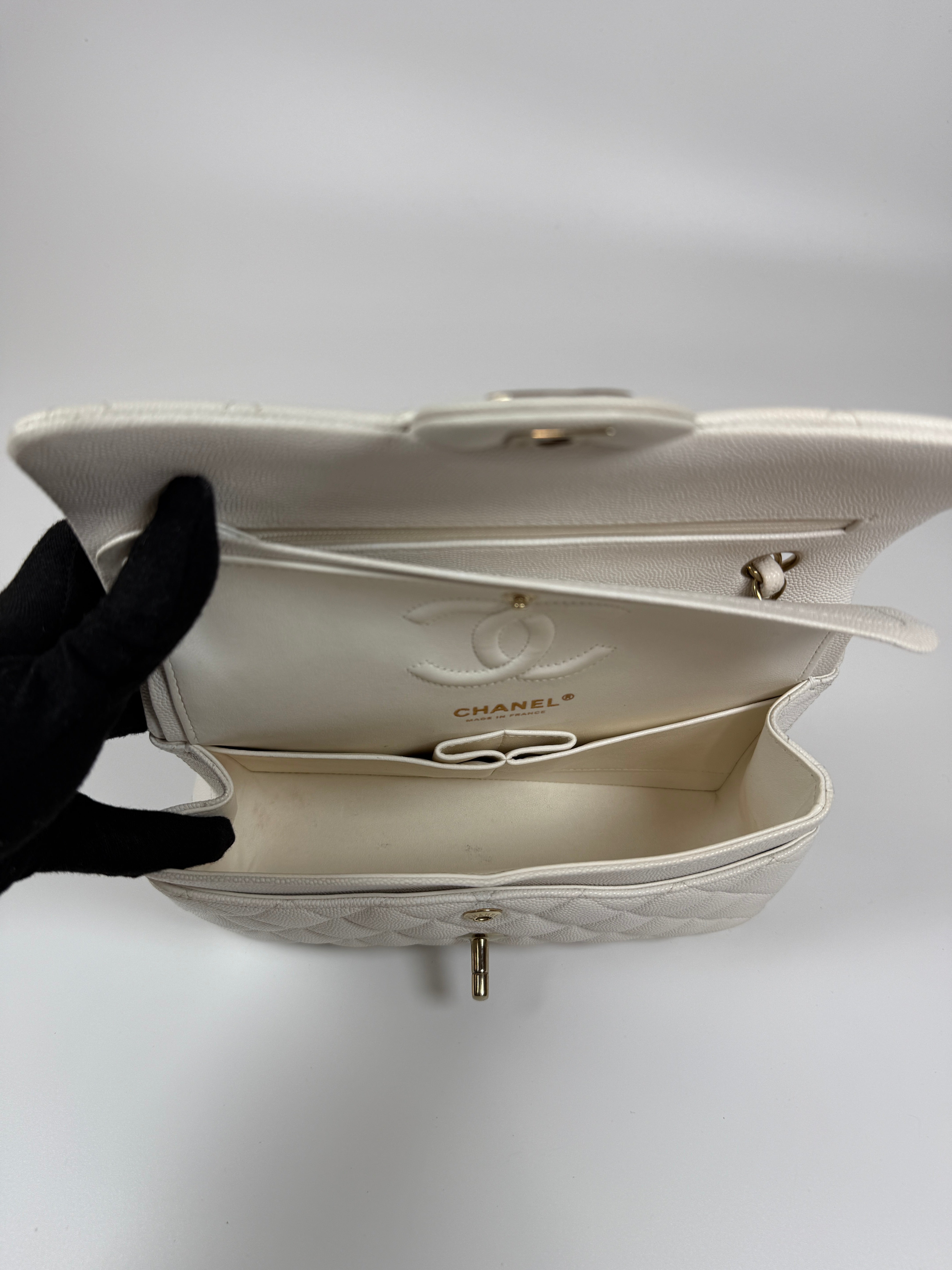 Authentic and preloved Chanel Small Classic Double Flap In White Caviar Leather With pale gold hardware. Very Good Condition. 100% Authenticity guarantee 