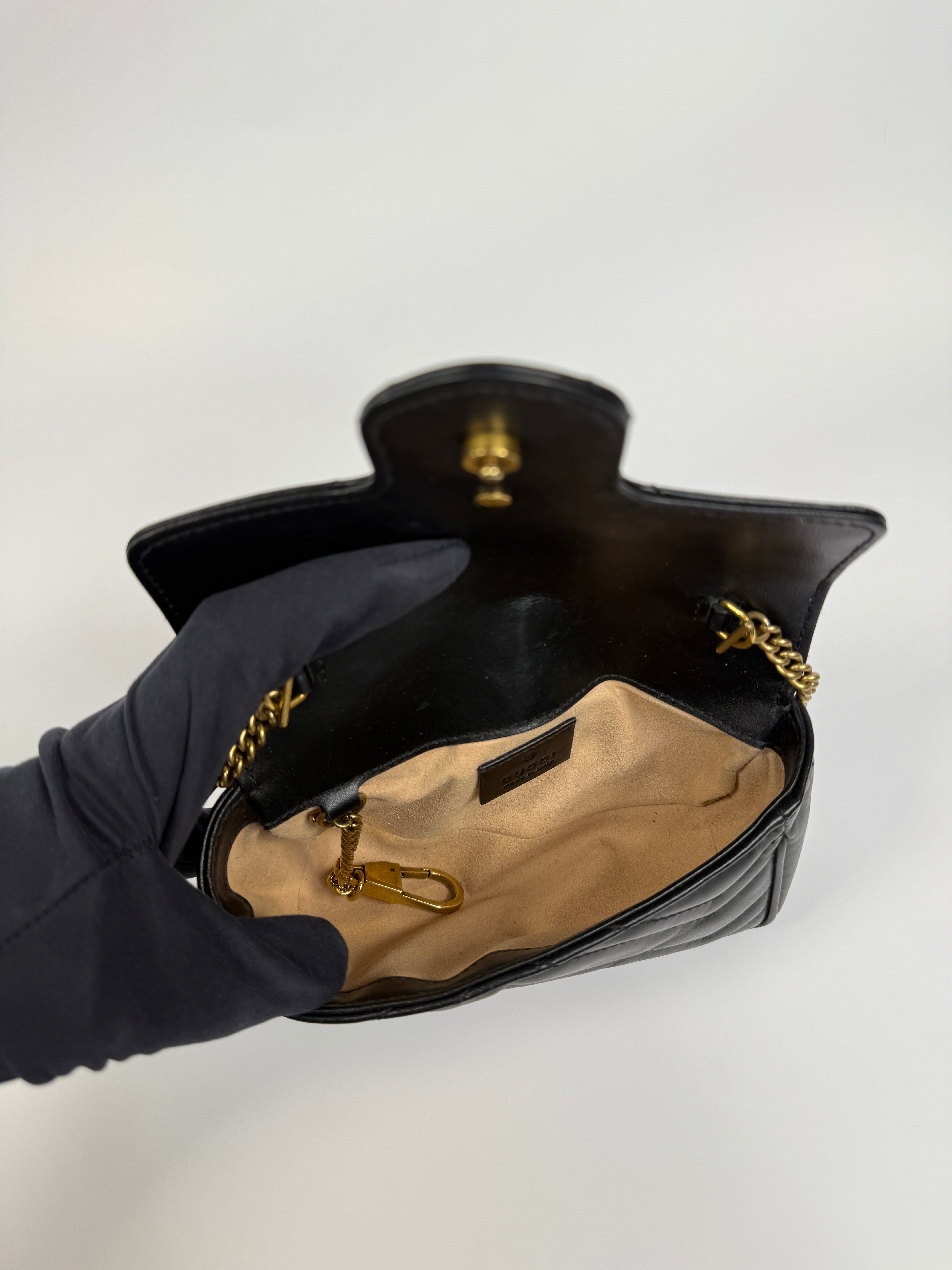 Authentic and preloved Gucci Marmont Matelassé Super Mini Bag In Black Leather With Gold Hardware in excellent condition 