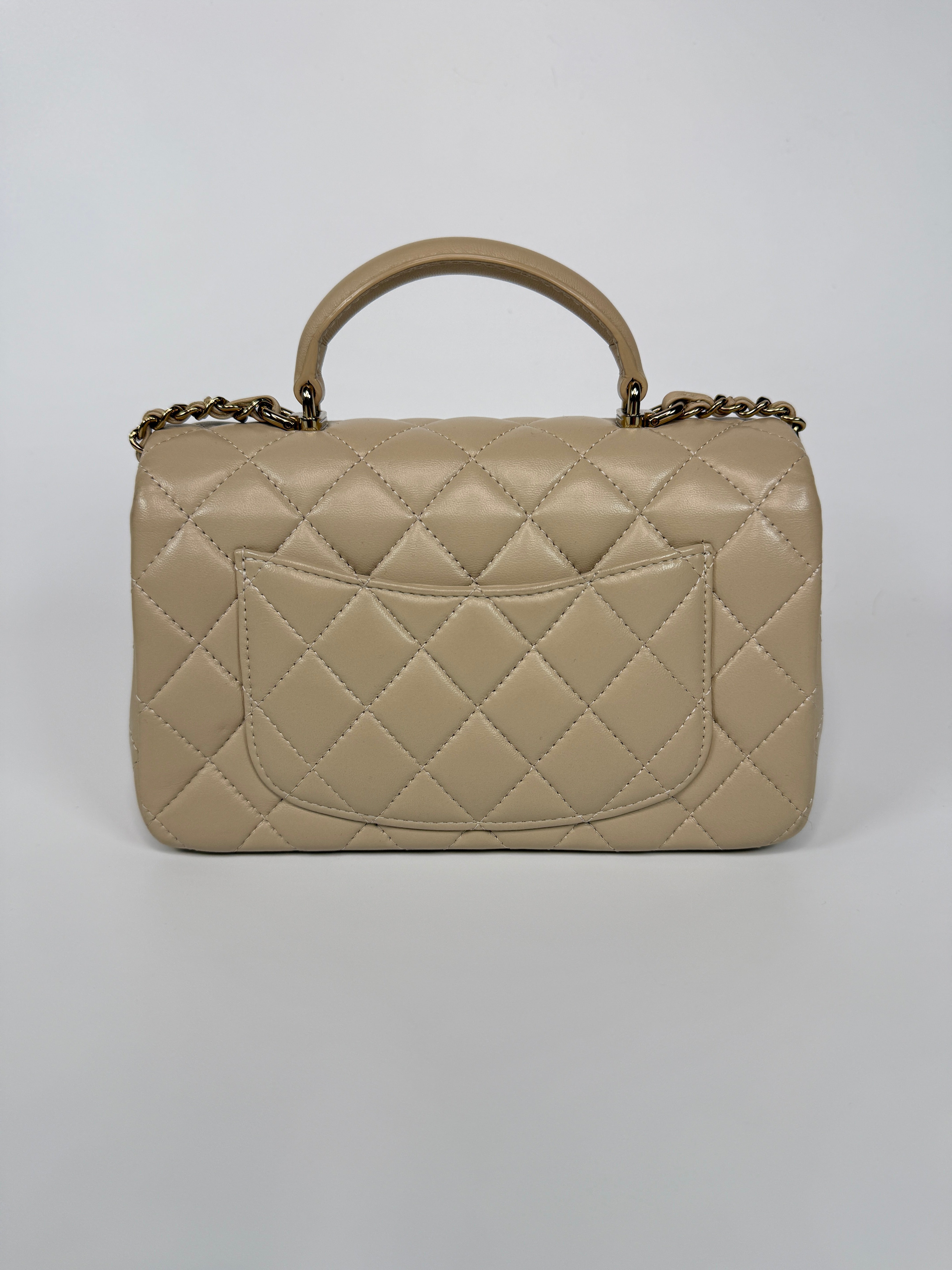 Authentic and preloved Chanel Mini Rectangle Top Handle In Ecru Lambskin With Gold Hardware in excellent condition, Fully insured next day delivery. Verified by Luxe Cheshire. 100% Authenticity guarantee,