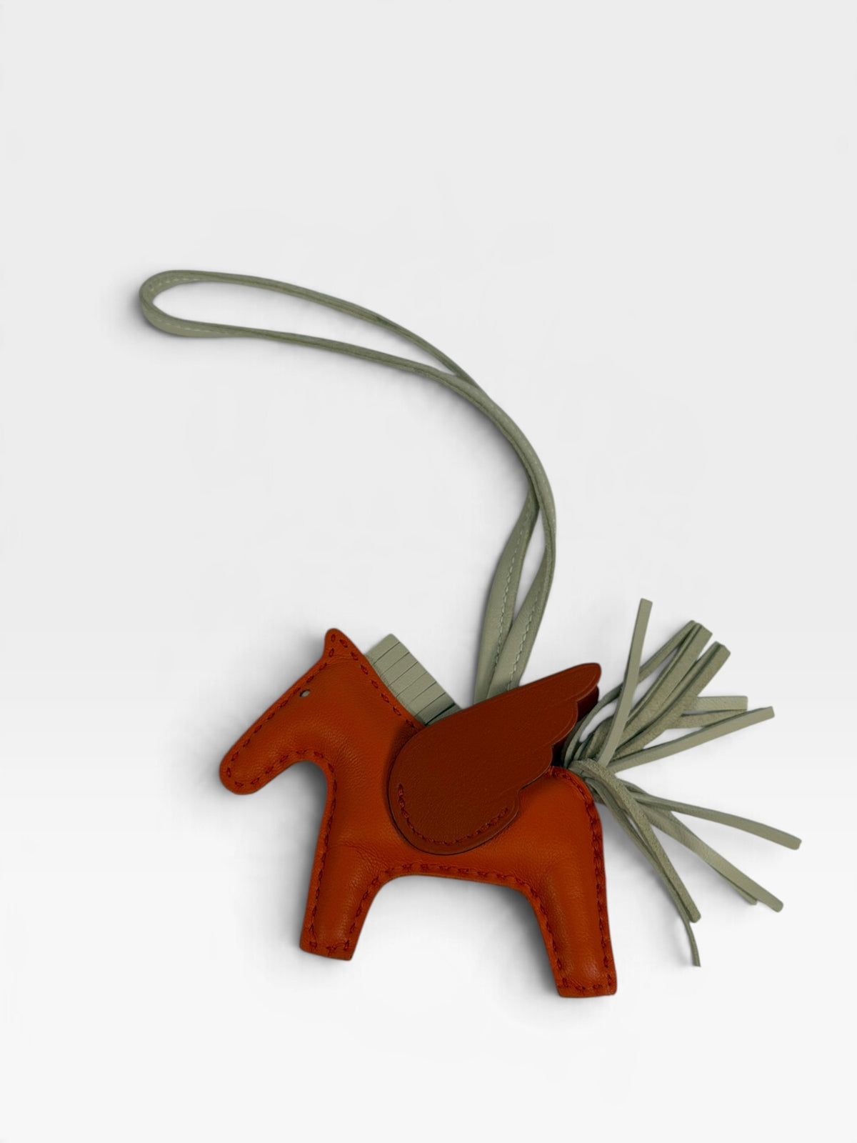 Hermès Rodeo Pegasus Charm In Orange Poppy, Craie & Terre Battue. 100% authentic and pre loved in excellent condition. 