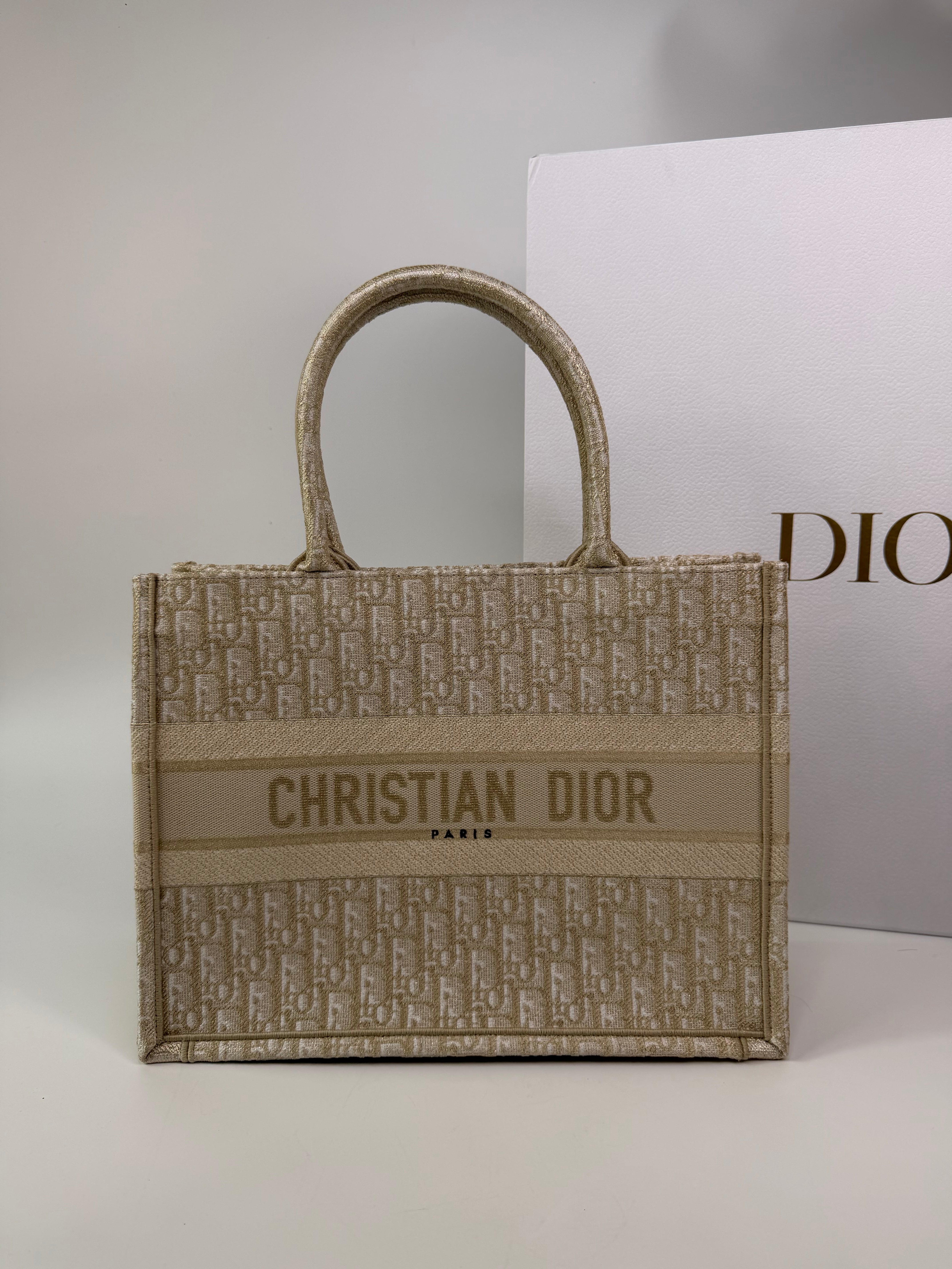 Christian Dior Medium Book Tote In Latte & Gold Tone Dioresque. Authentic and preloved in new and unused condition. 100% trusted guarantee