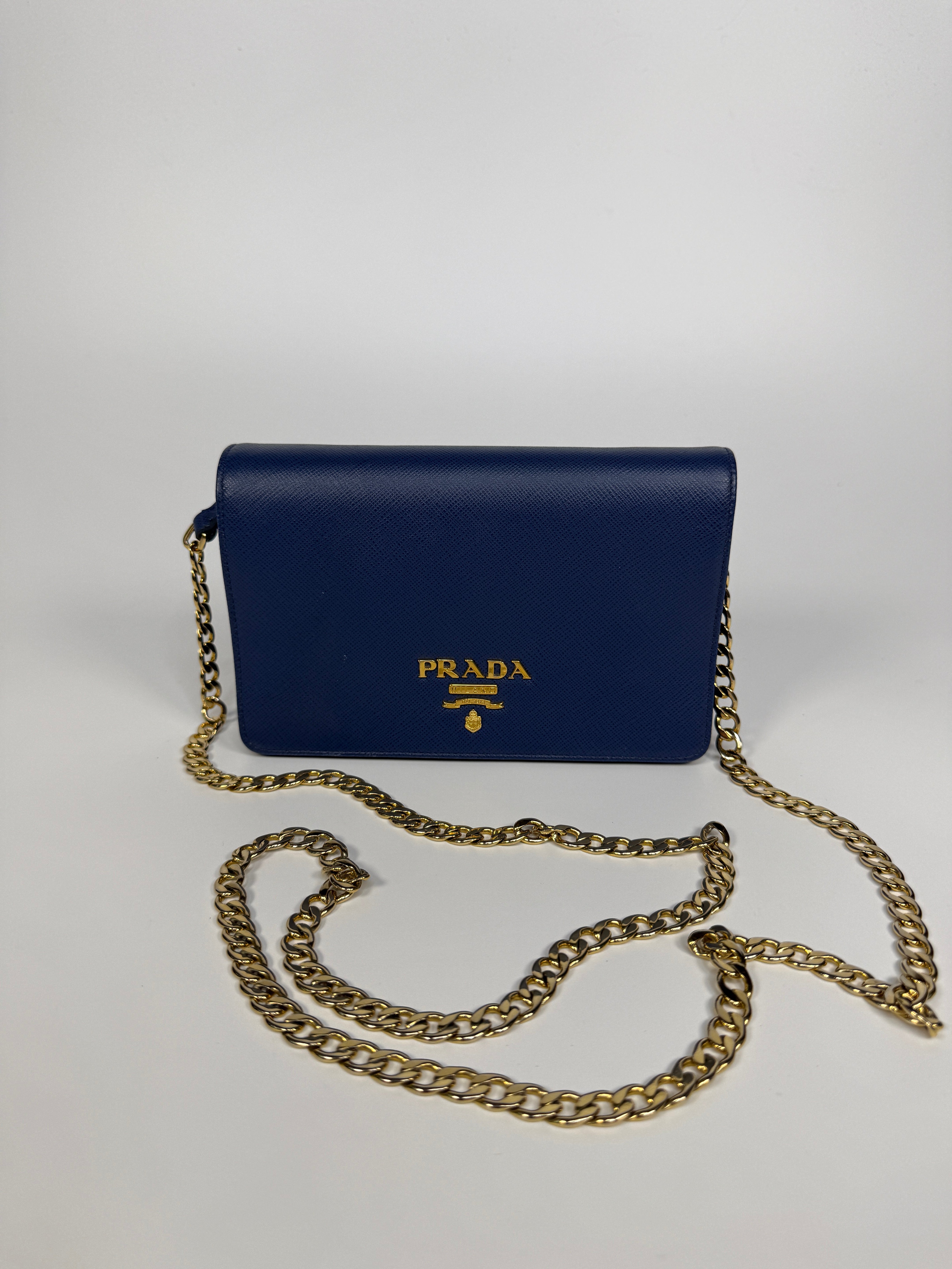 Authentic and preloved Prada Wallet Chain Bag In Blue Saffiano Leather With Gold Hardware. Very Good condition. 100% Authenticity guarantee 