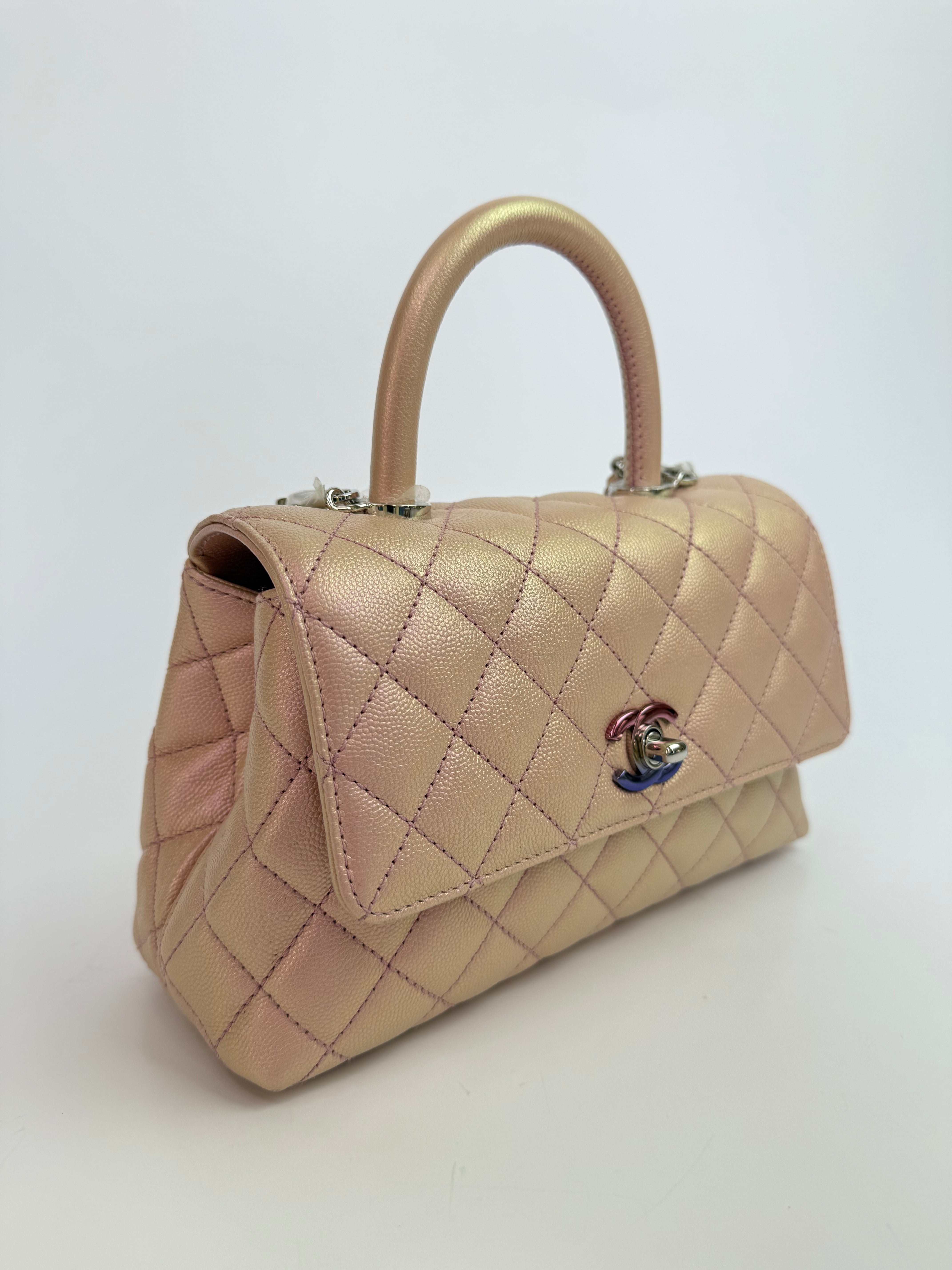 Authentic pre-loved Chanel Small Coco In Iridescent Pink Caviar With Rainbow Hardware. 