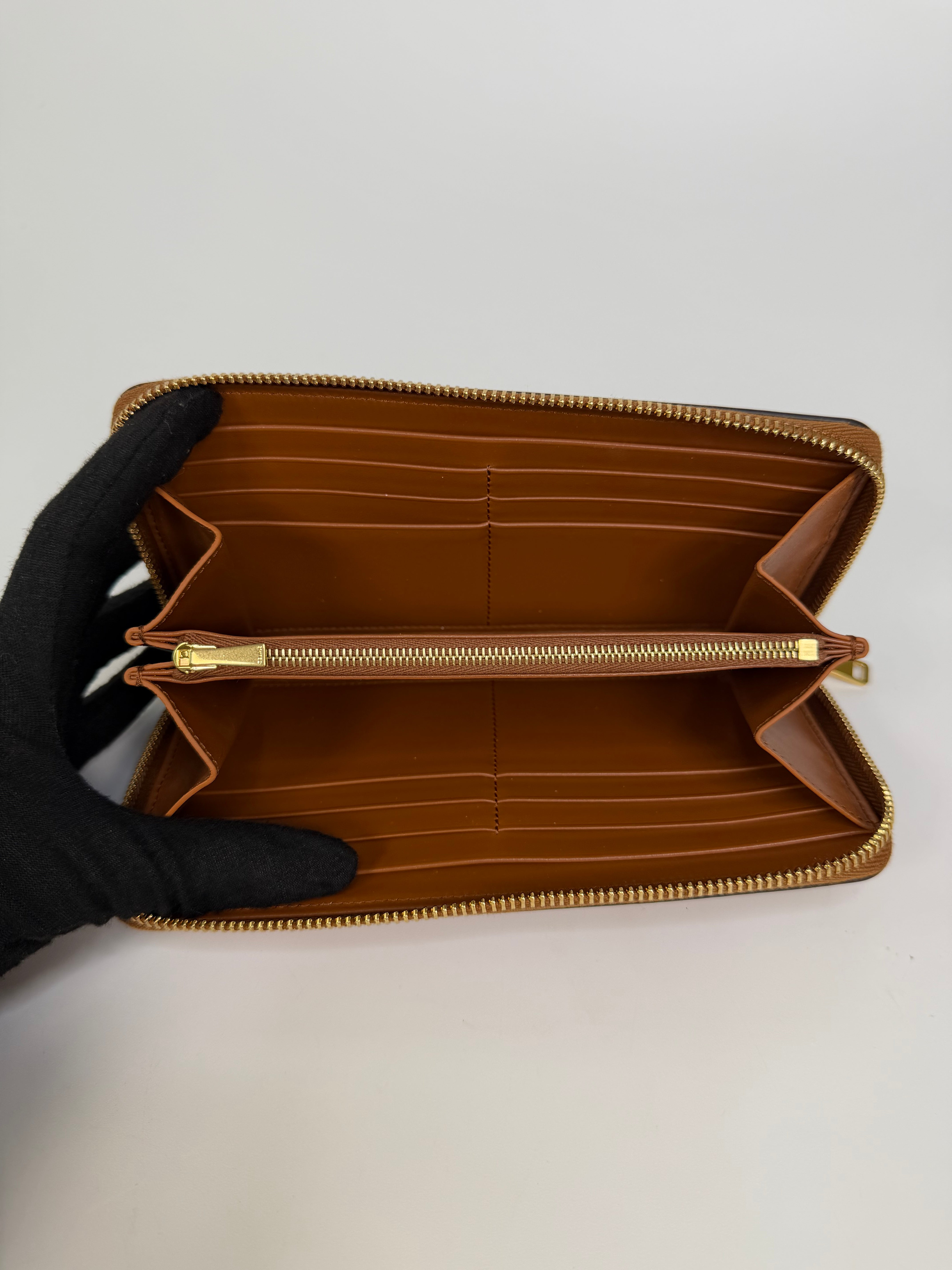 Celine Triomphe Long Wallet In Tan Calfskin With Gold Hardware. Authentic and preloved in excellent condition