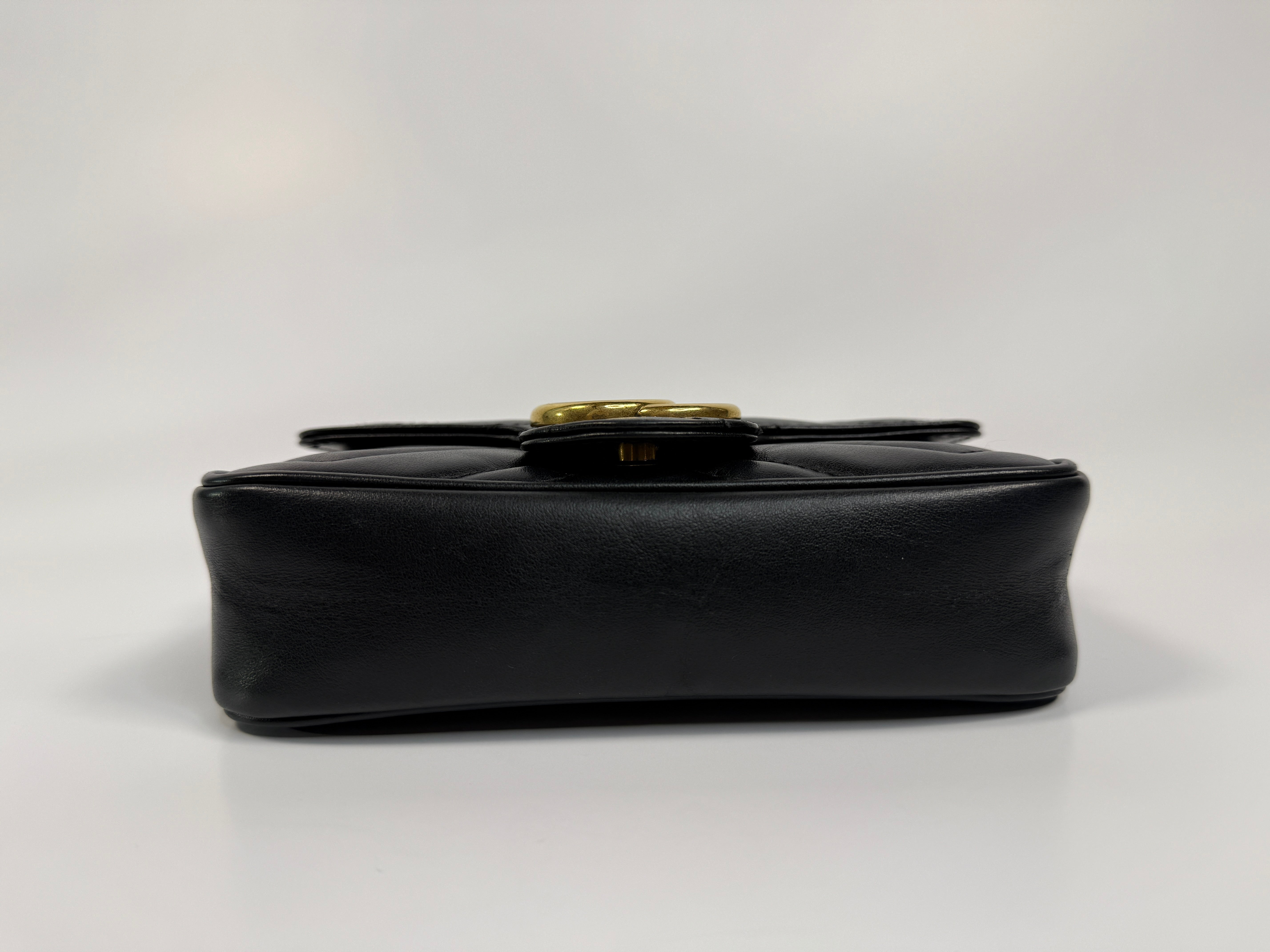 Authentic and preloved Gucci Marmont Matelassé Super Mini Bag In Black Leather With Gold Hardware in excellent condition 