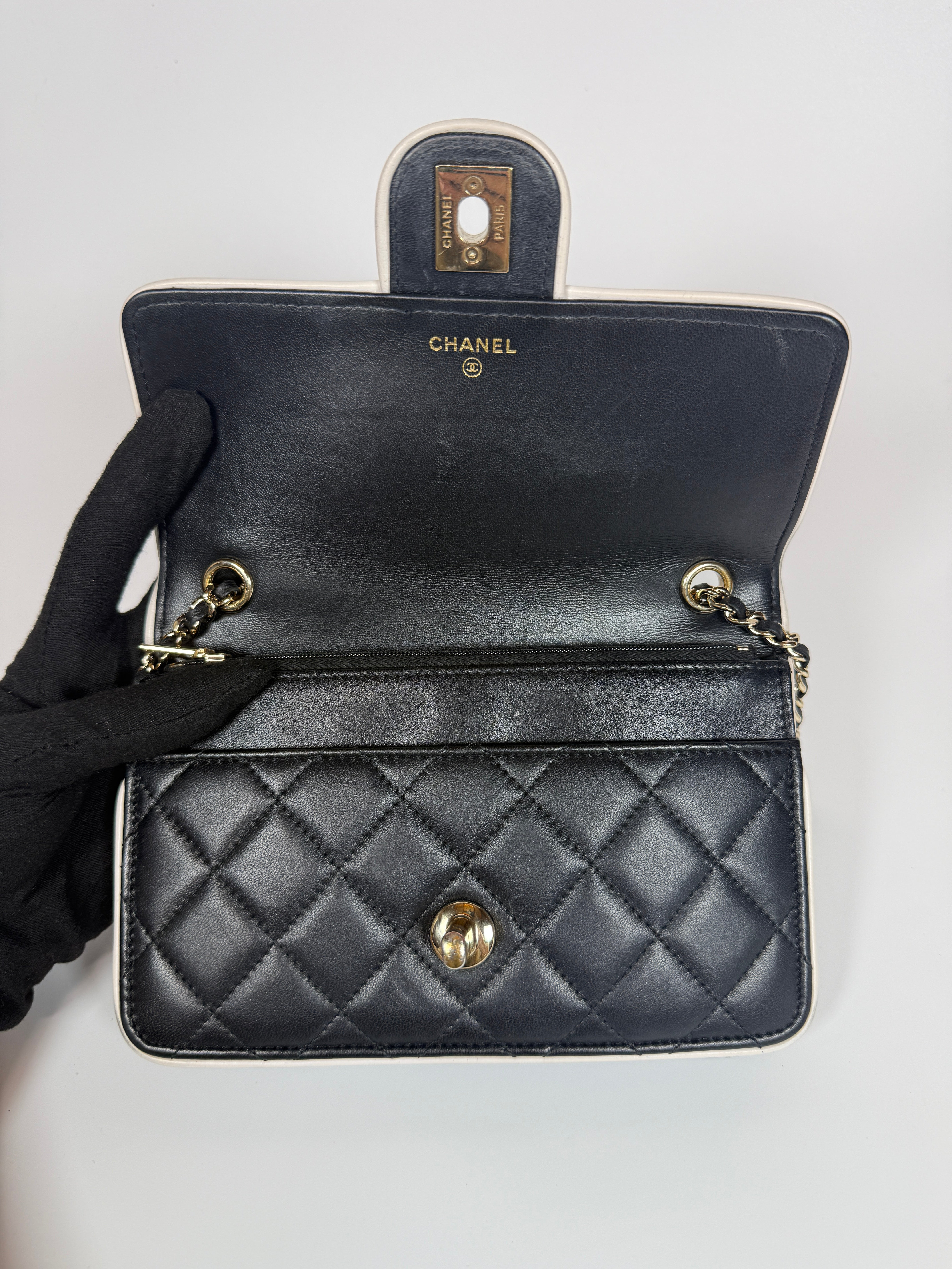 Authentic and preloved Chanel Wallet On Chain In Black & White Lambskin Leather With Pale Gold Hardware. Very Good Condition. 100% Authenticity Guarantee 