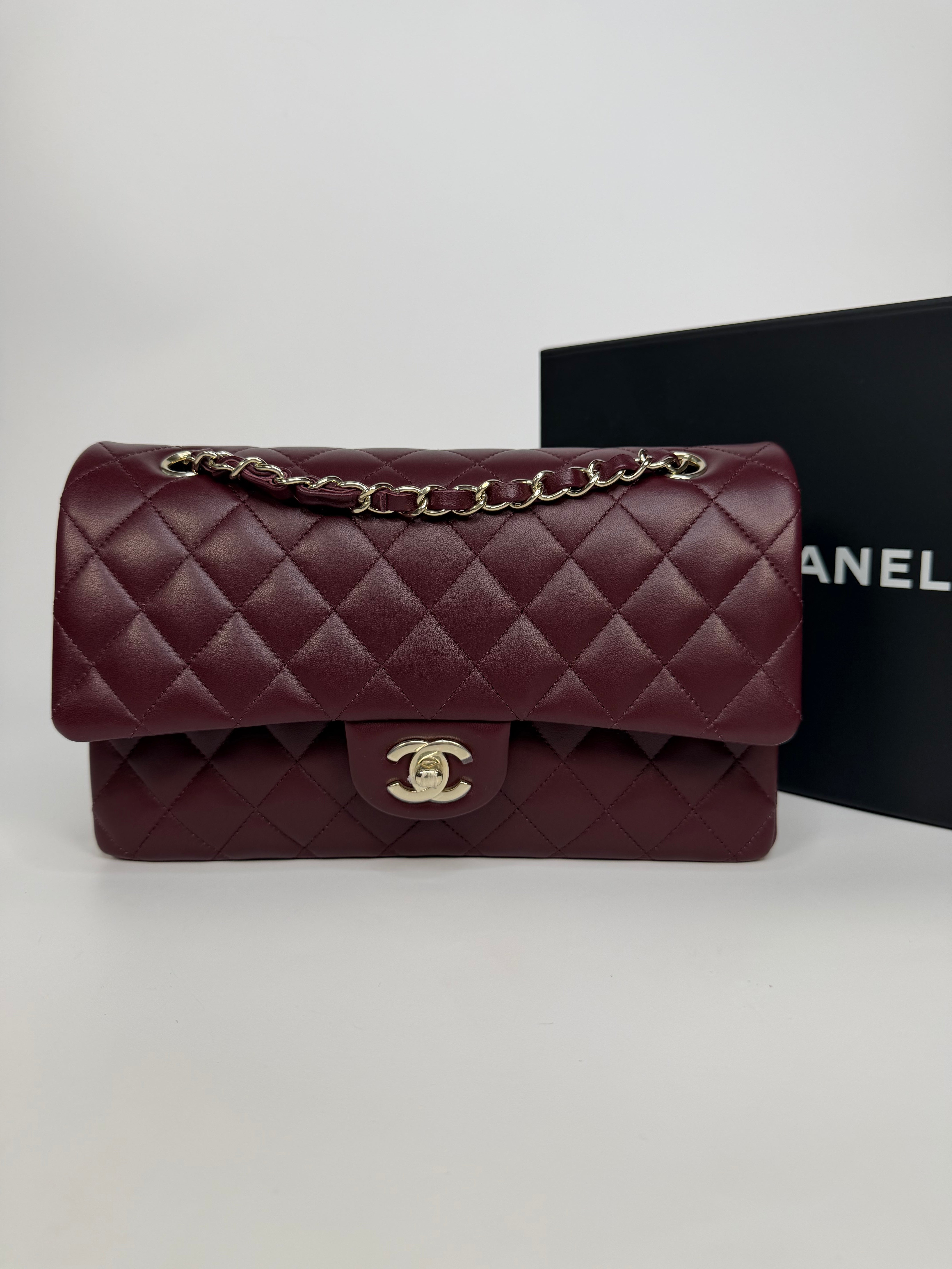 Chanel Medium Classic Double Flap Burgundy Lambskin Leather With Pale Gold Hardware. Authentic and preloved in excellent condition with 100% authenticity guarantee.