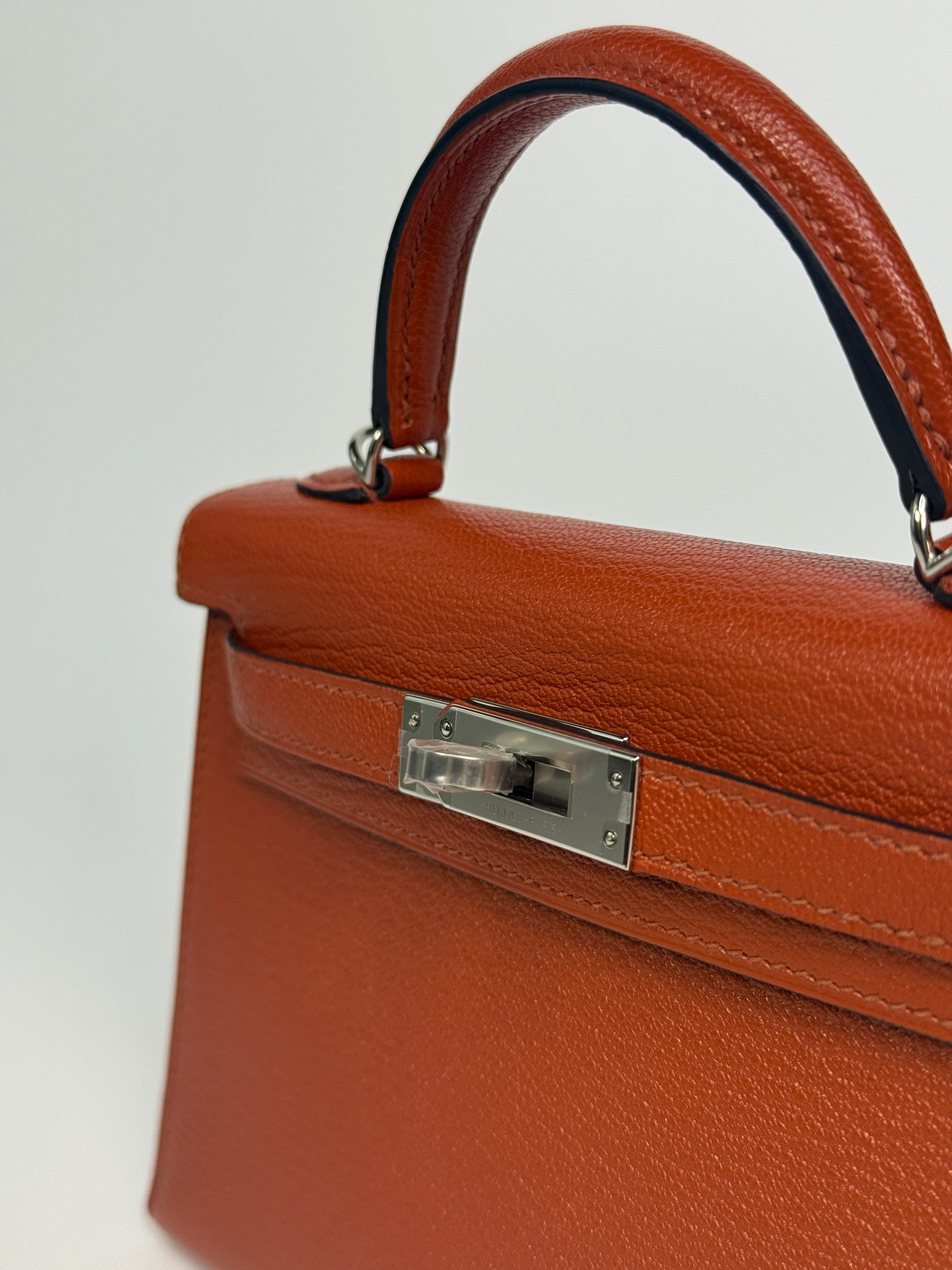 Hermès Mini Kelly In Cuivre Chèvre Mysore Leather With Palladium Hardware. Authentic and preloved in new and unused condition