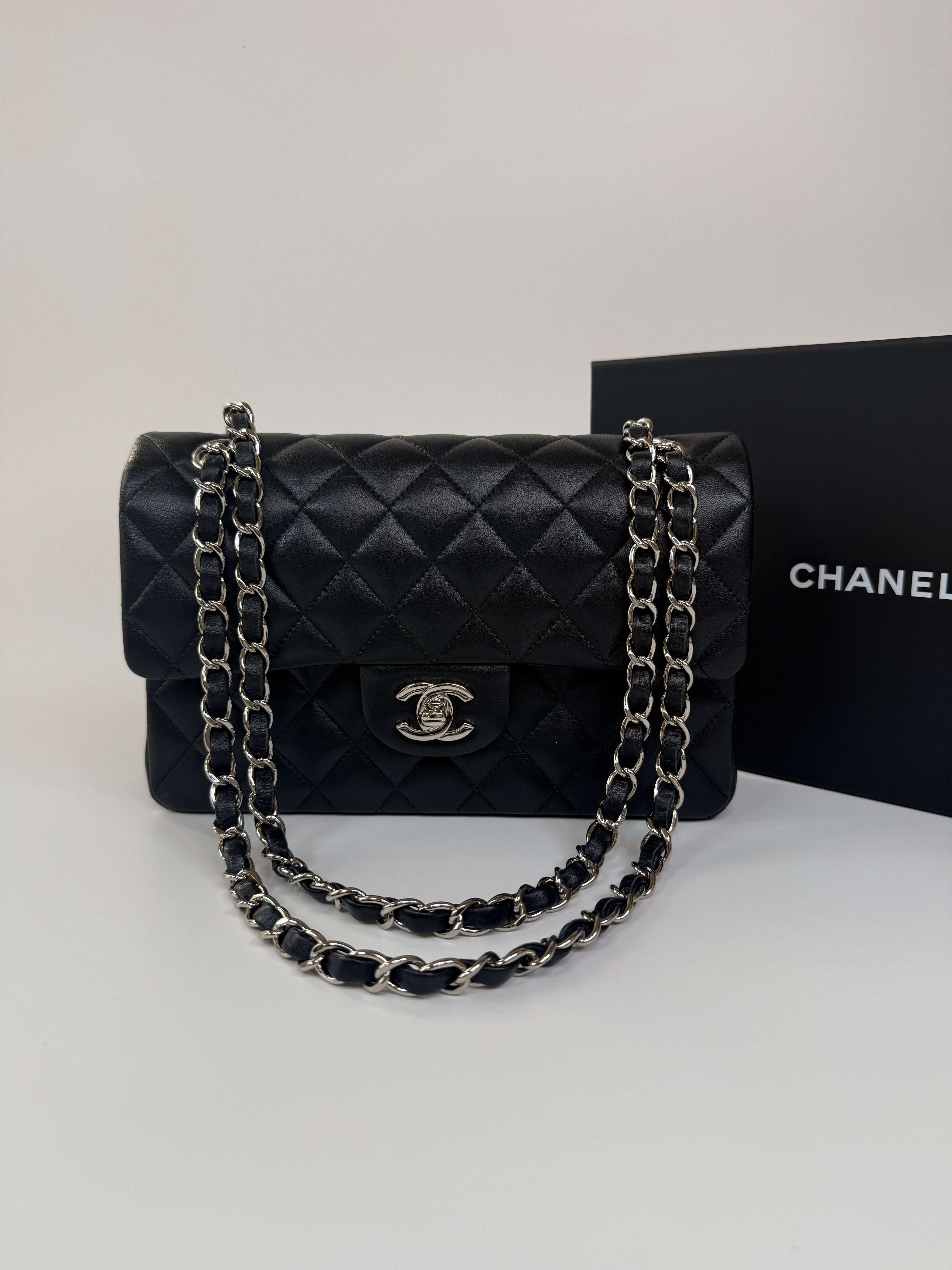 Chanel Small Classic Double Flap In Black Lambskin Leather With Silver Hardware Authentic and preloved in excellent condition. 100% Authenticity guarantee