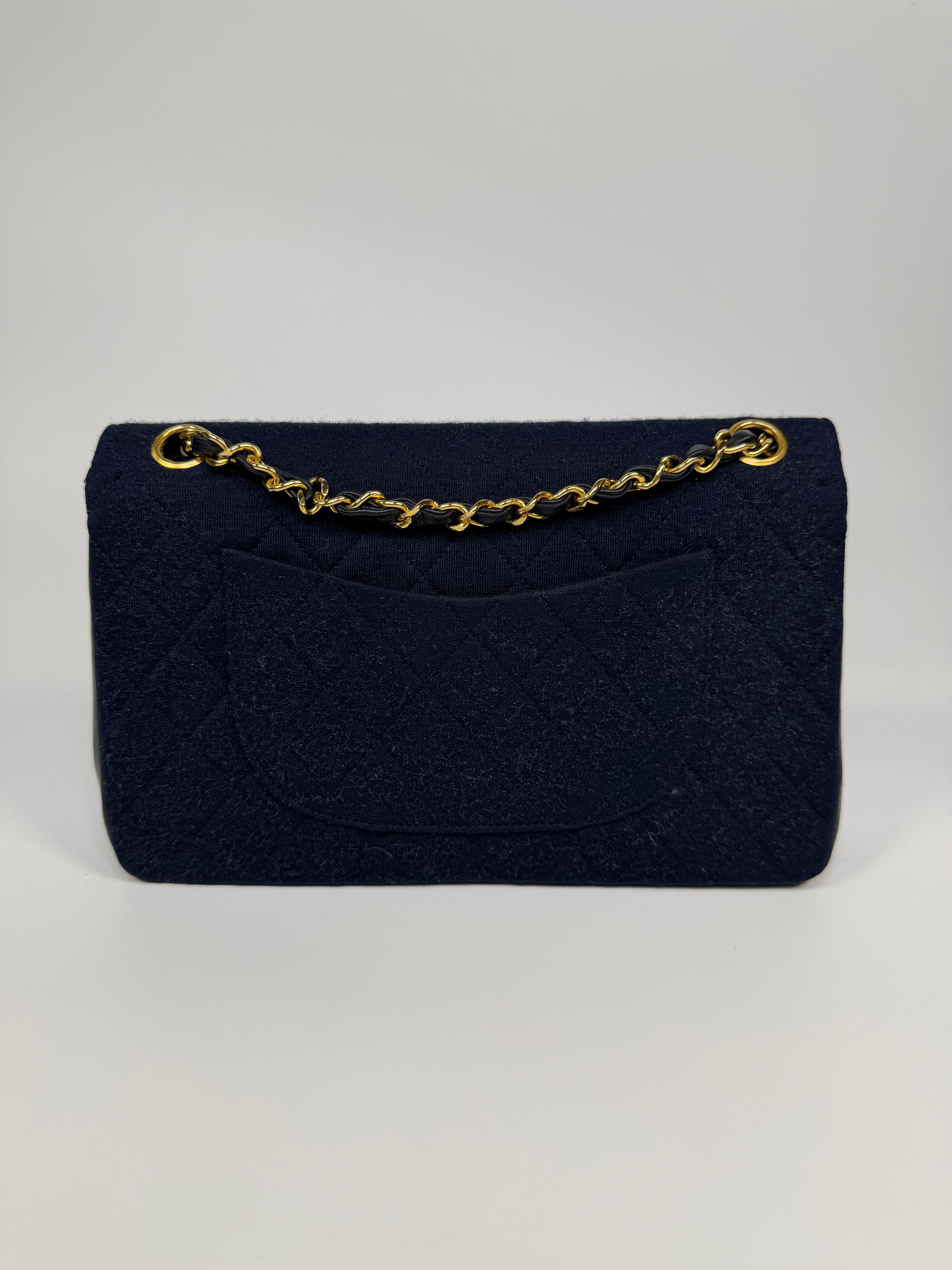 Chanel Vintage Medium Double Flap Navy Cotton With 24Kt Gold Hardware. Authentic and preloved in excellent condition.