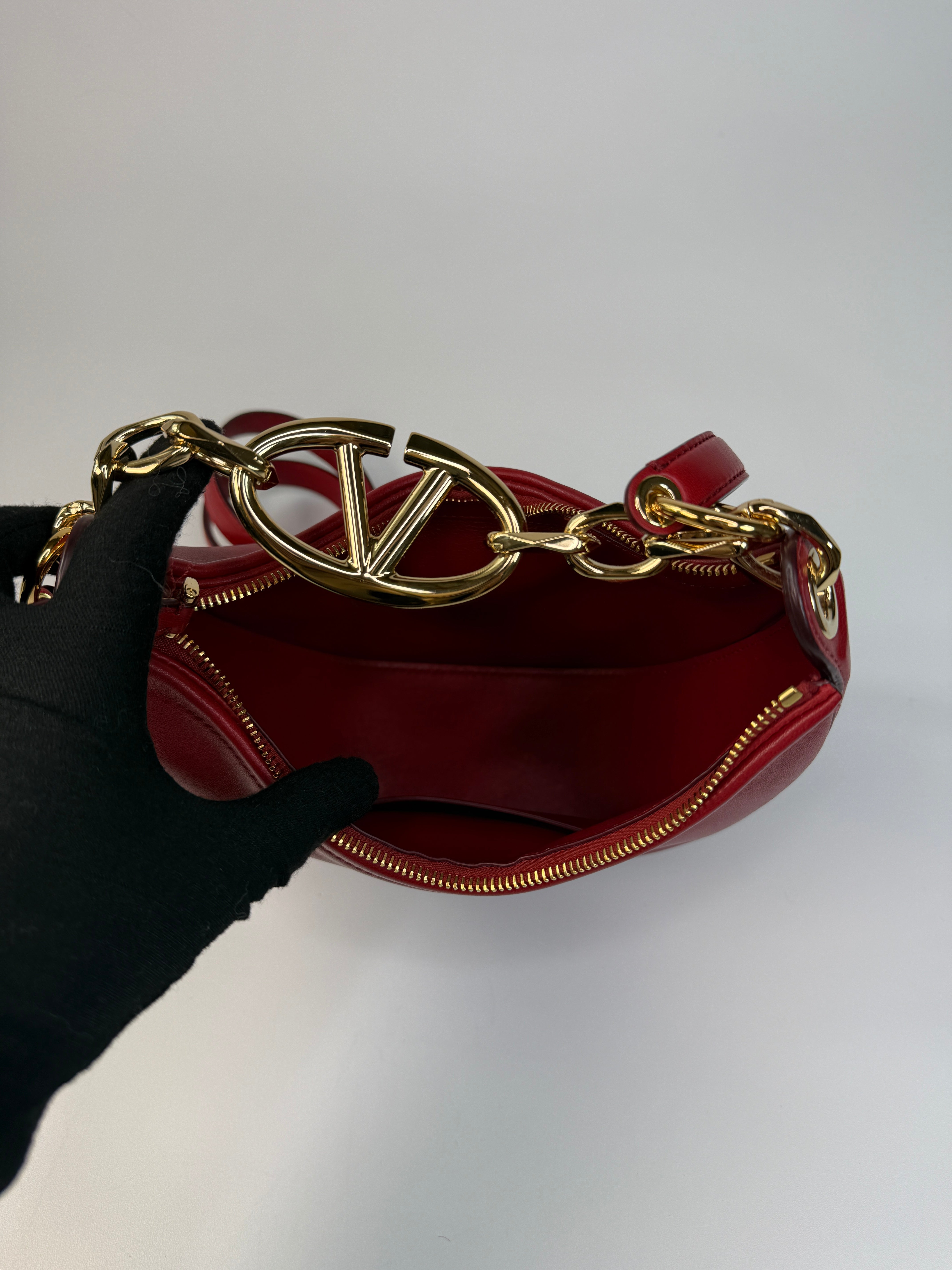 Authentic and preloved Valentino Garavani VLOGO Half Moon Bag  In Red Leather With Gold Hardware 