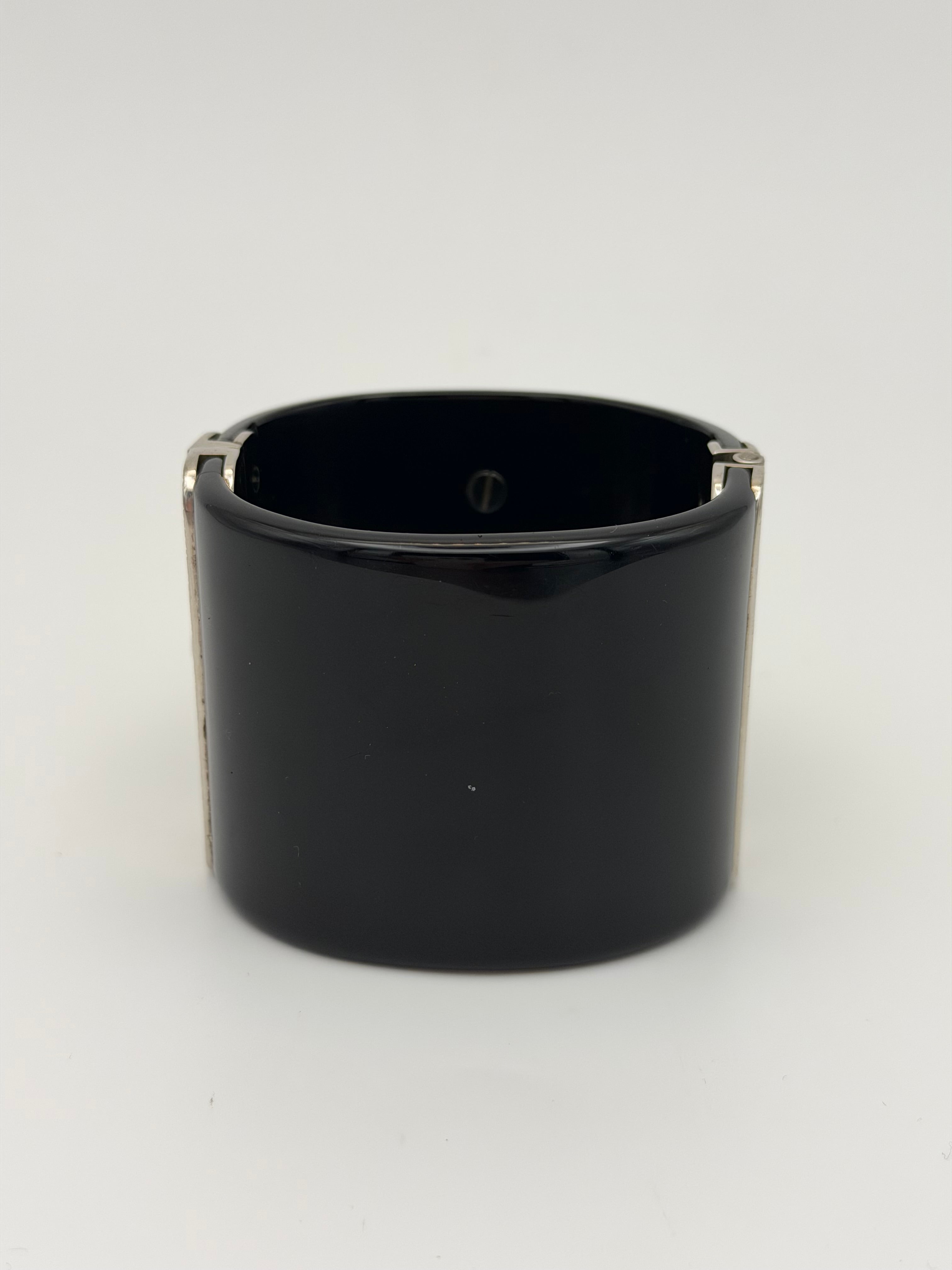 Chanel cc Black resin and rhinestone cuff in black enamel. Very Good condition. Authentic and preloved. 