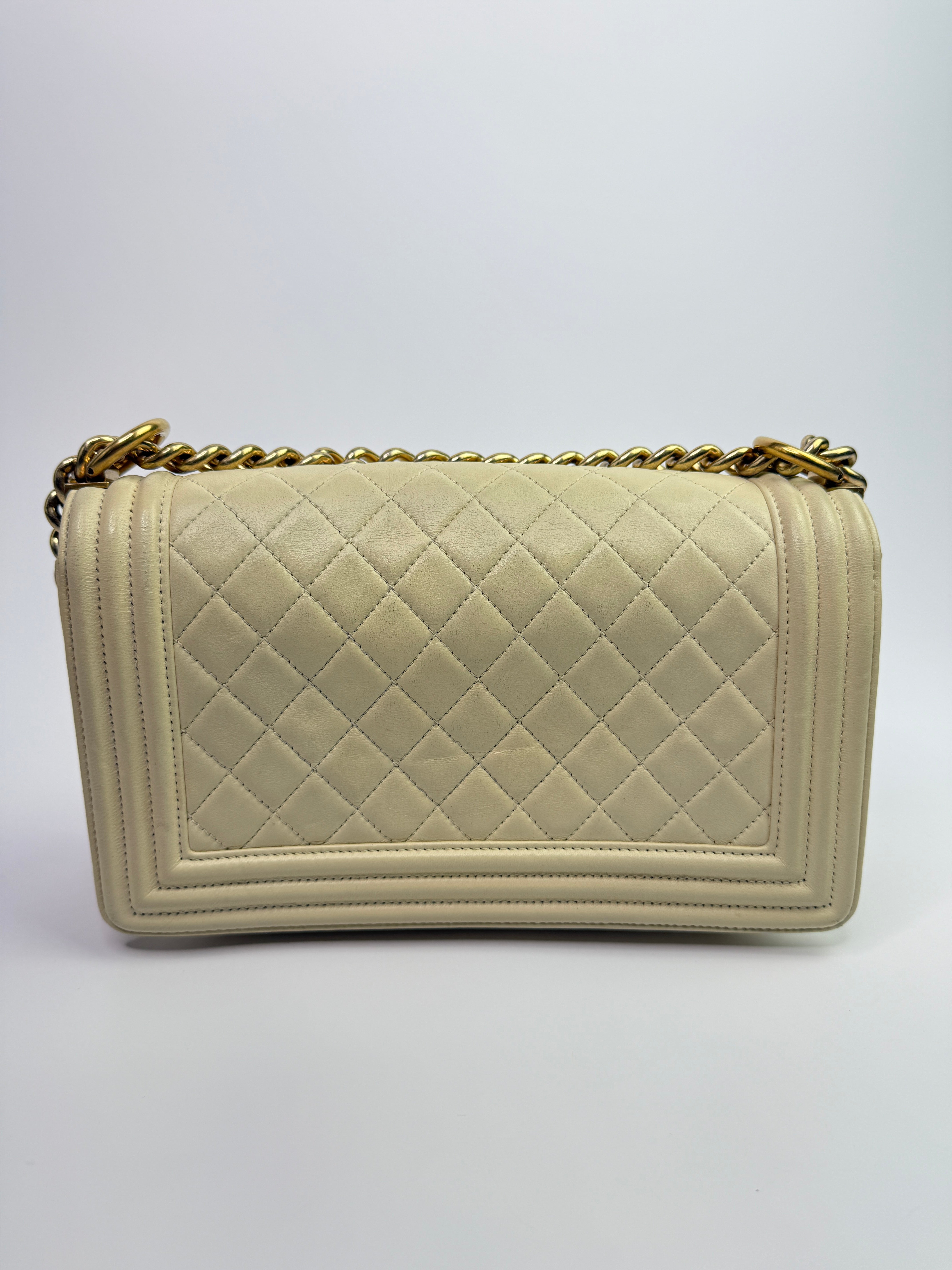 Authentic pre-loved Chanel Boy Bag Medium In Cream Lambskin With Gold Hardware. 