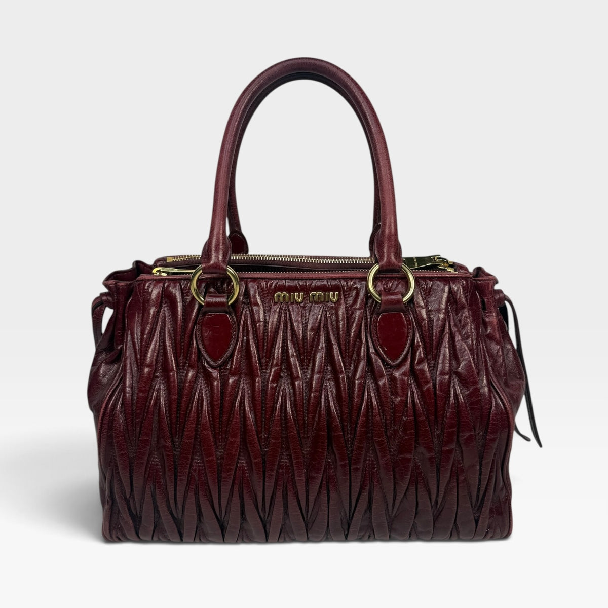 Miu Miu Bauletto Tote Bag In Burgundy Matelasse Leather With Gold Hardware. 100% authentic and pre loved in excellent condition. 