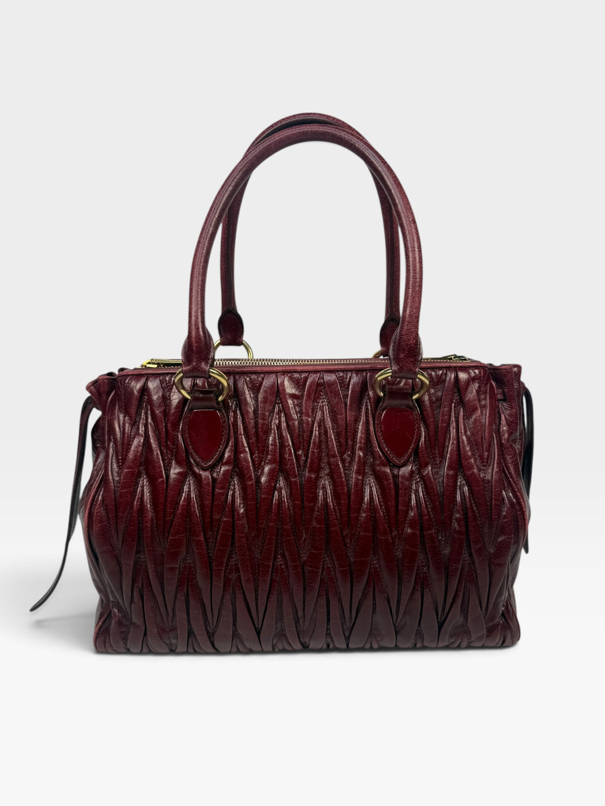 Miu Miu Bauletto Tote Bag In Burgundy Matelasse Leather With Gold Hardware. 100% authentic and pre loved in excellent condition. 